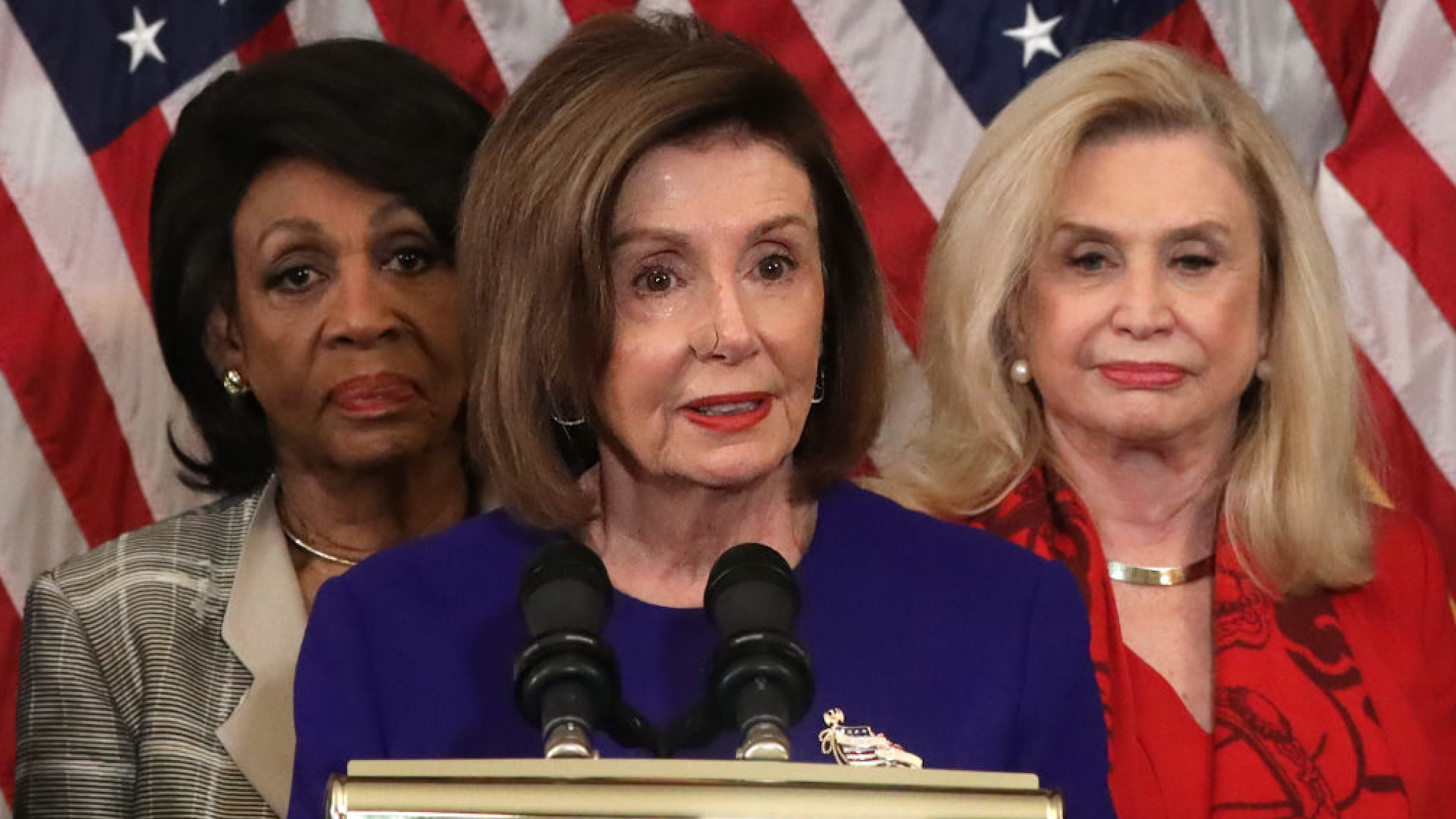 Speaker of the House Rep. Nancy Pelosi (D-CA) (C) speaks as Chairwoman of House Financial Services Committee Rep. Maxine Waters (D-CA) (L) and Chairwoman of House Oversight and Reform Committee Rep. Carolyn Maloney (D-NY) (R) listen during a news conference at the U.S. Capitol December 10, 2019 in Washington, DC.