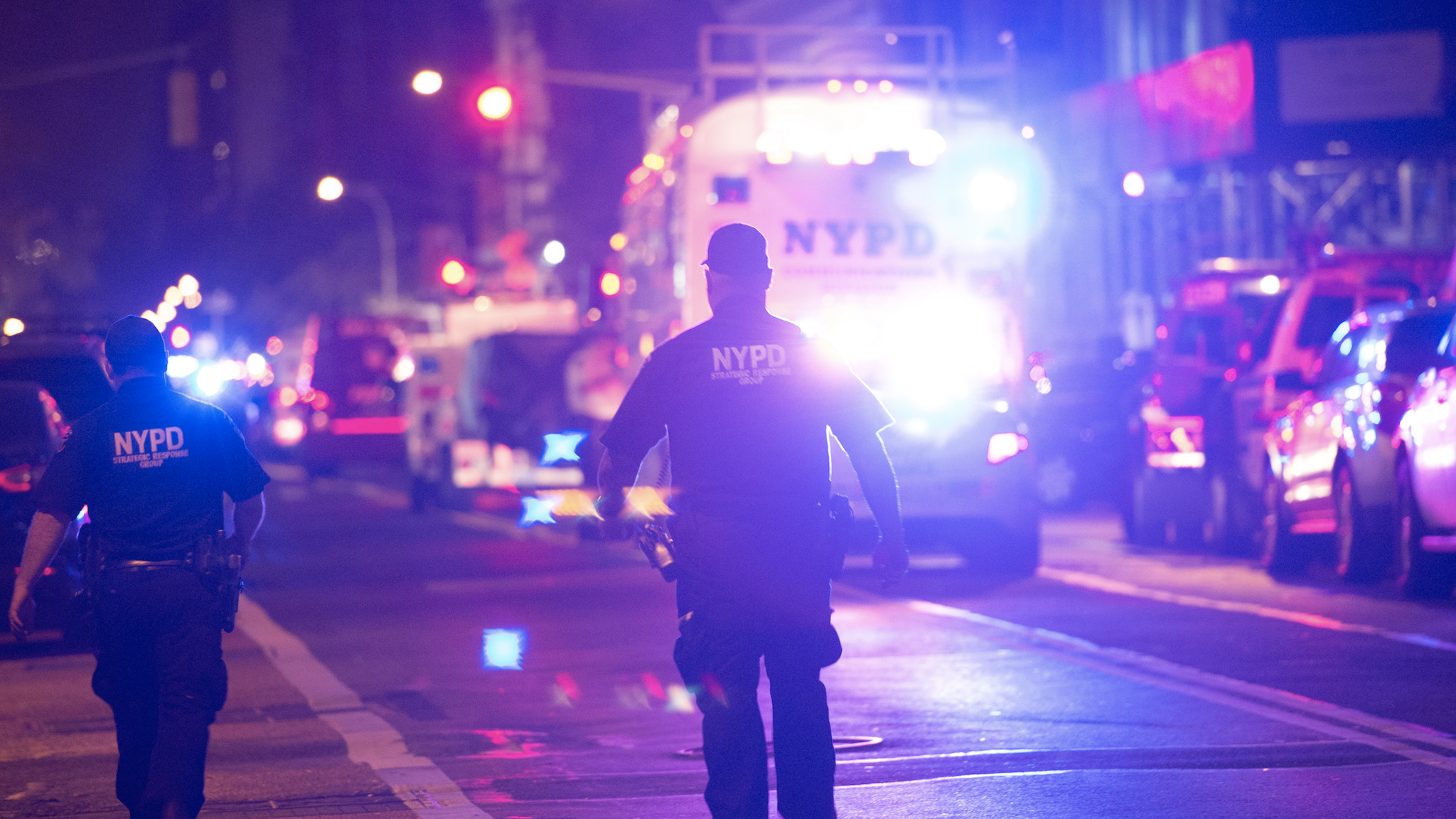 Police and first responders walk down a blocked off road near the site of an alleged bomb explosion on West 23rd Street on September 17, 2016, in New York. An explosion in New York's upscale and bustling Chelsea neighborhood injured at least 25 people, none of them in a life-threatening condition, late Saturday, the fire department said.