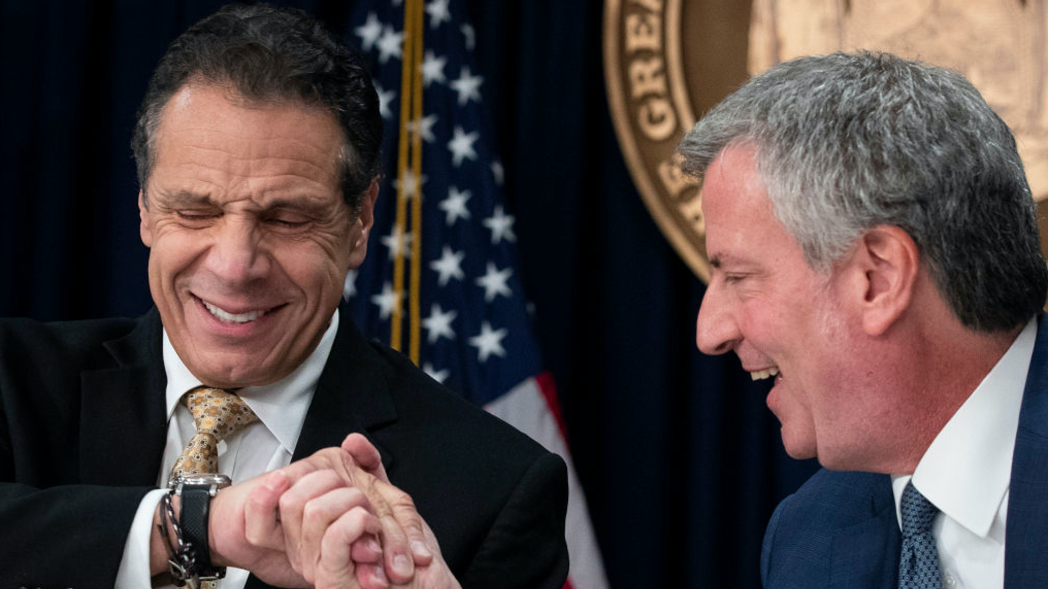New York Governor Andrew Cuomo and New York City Mayor Bill de Blasio shake hands during a press conference to discuss Amazon's decision to bring a new corporate location to New York City, November 13, 2018 in New York City.