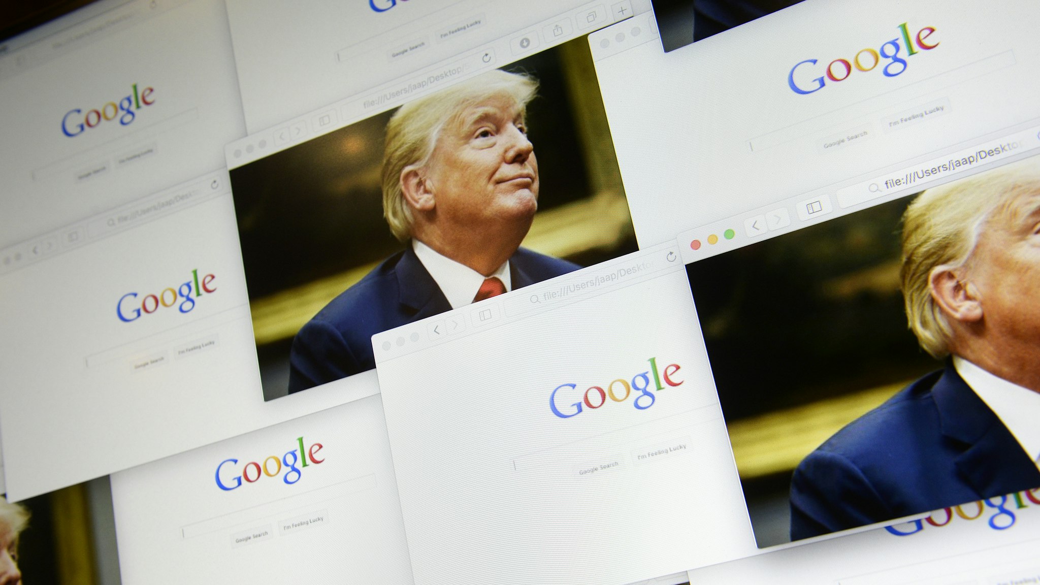 Google logos are seen in this photo illustration together with images of Donald Trump on September 5, 2018.