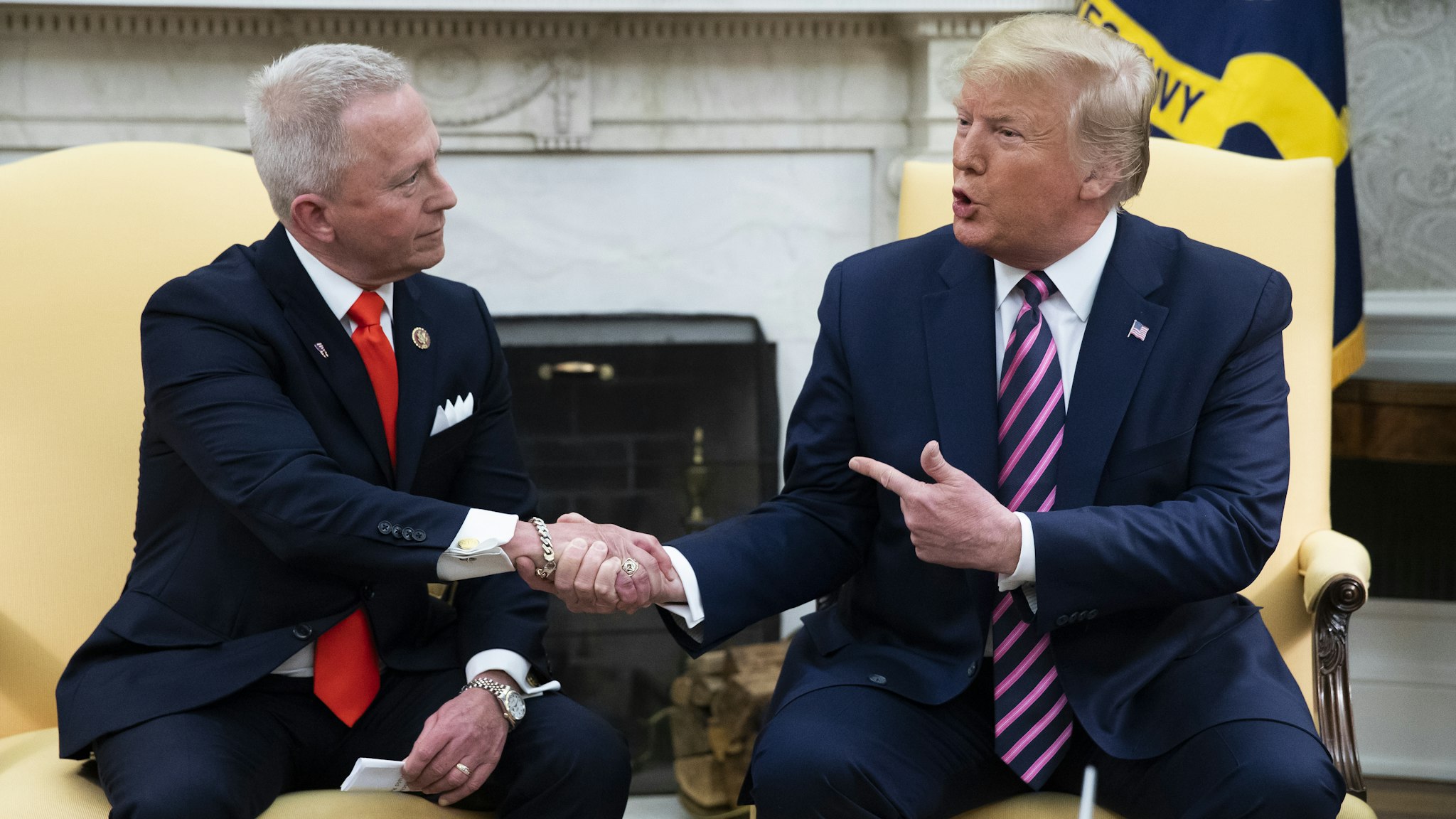 U.S. President Donald Trump shakes hands with Representative Jeff Van Drew, a Democrat from New Jersey, left, in the Oval Office of the White House in Washington, D.C., U.S., on Thursday, Dec. 19, 2019. Trump announced that Van Drew is switching parties to become a Republican after he voted against impeaching the president on Wednesday.