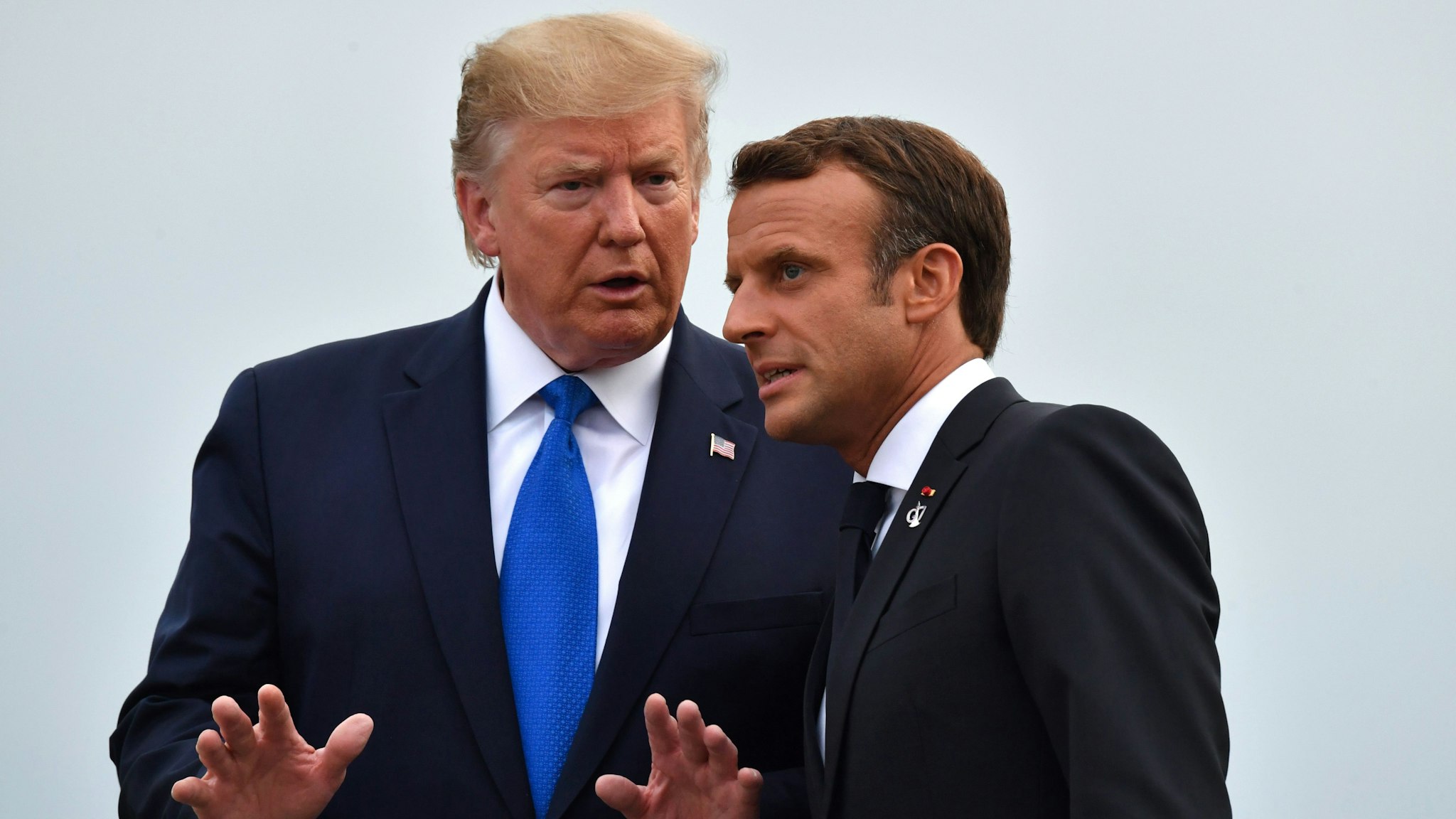 French President Emmanuel Macron (R) chats with US President Donald Trump at the Biarritz lighthouse, southwestern France, ahead of a working dinner on August 24, 2019, on the first day of the annual G7 Summit attended by the leaders of the world's seven richest democracies, Britain, Canada, France, Germany, Italy, Japan and the United States. - EU leaders rounded on US President Donald Trump over his trade threats at a G7 summit in France overshadowed by trans-Atlantic tensions and worries about the global economy.