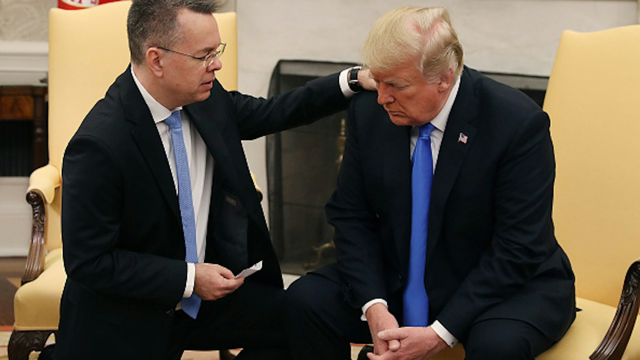 WASHINGTON, DC - OCTOBER 13: U.S. President Donald Trump and American evangelical Christian preacher Andrew Brunson (L) participate in a prayer in the Oval Office a day after he was released from a Turkish jail, at the White House on October 13, 2018 in Washington, DC. Brunson was detained for two years in Turkey on espionage and terrorism-related charges that the pastor said were false.