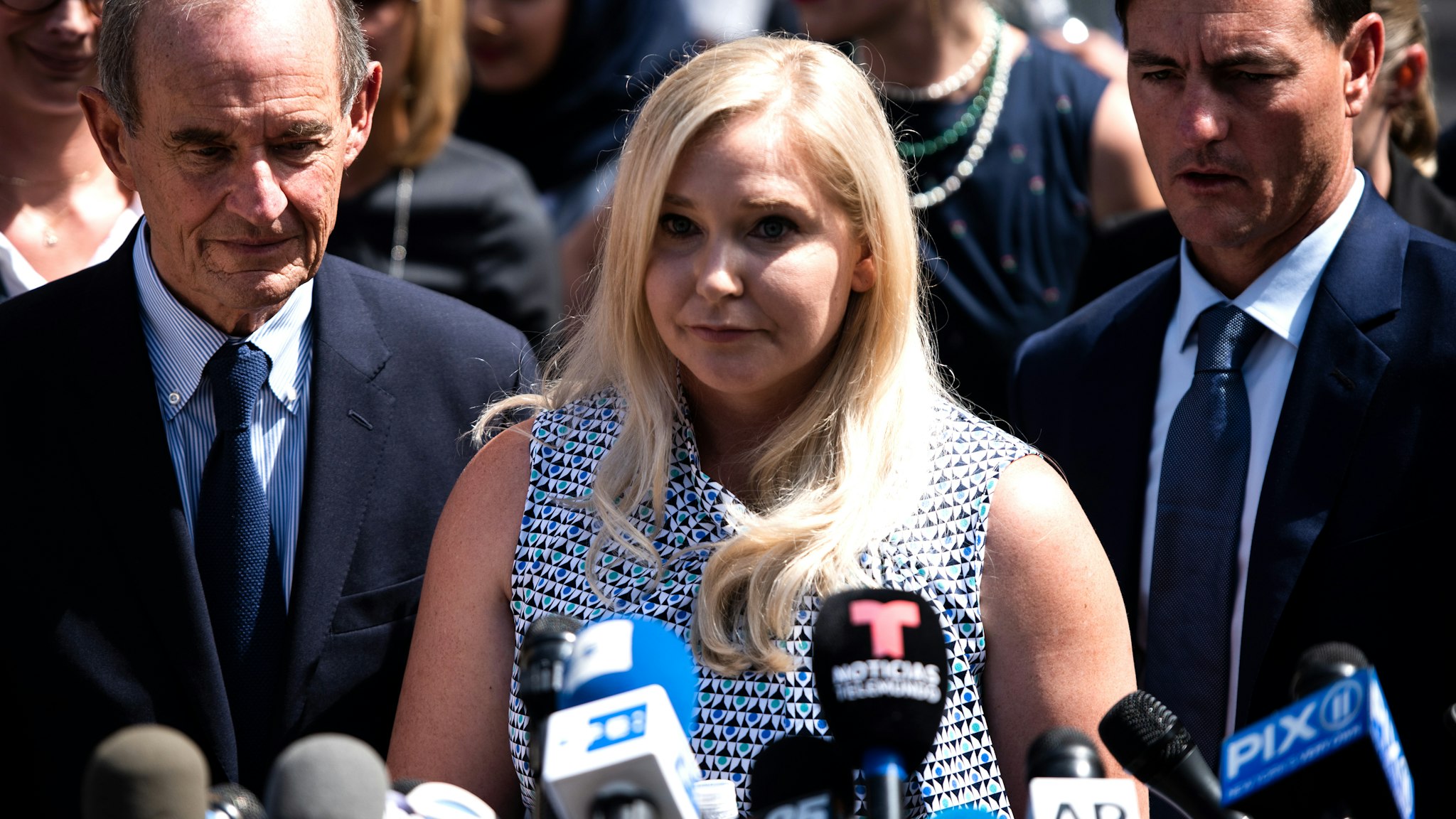 Virginia Giuffre, an alleged victim of Jeffrey Epstein, center, pauses while speaking with members of the media outside of federal court in New York, U.S., on Tuesday, Aug. 27, 2019. Epstein, a convicted pedophile, killed himself in prison earlier this month while awaiting trial on charges of conspiracy and trafficking minors for sex.