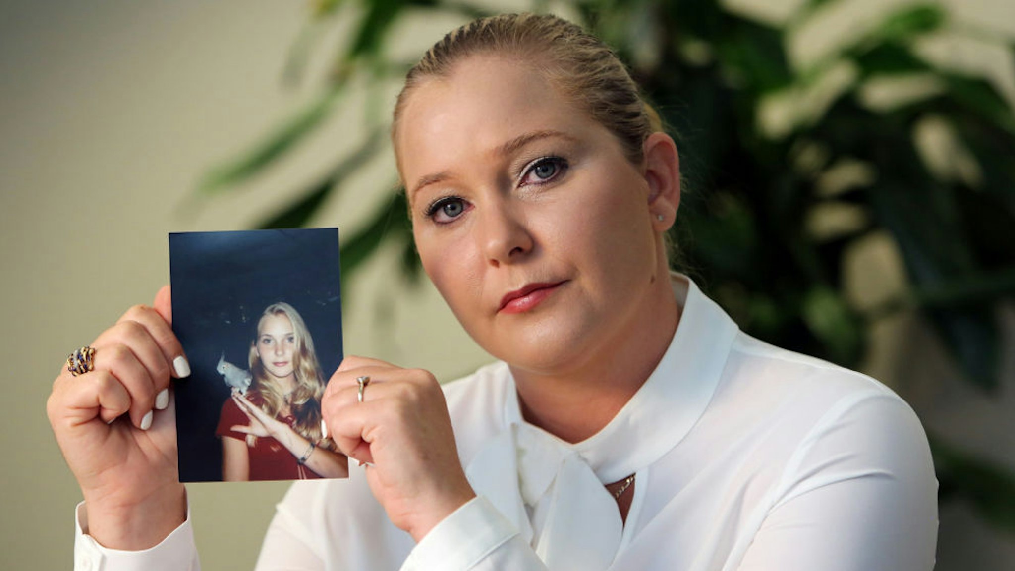 Virginia Roberts holds a photo of herself at age 16, when she says Palm Beach multimillionaire Jeffrey Epstein began abusing her sexually. (Emily Michot/Miami Herald/TNS)