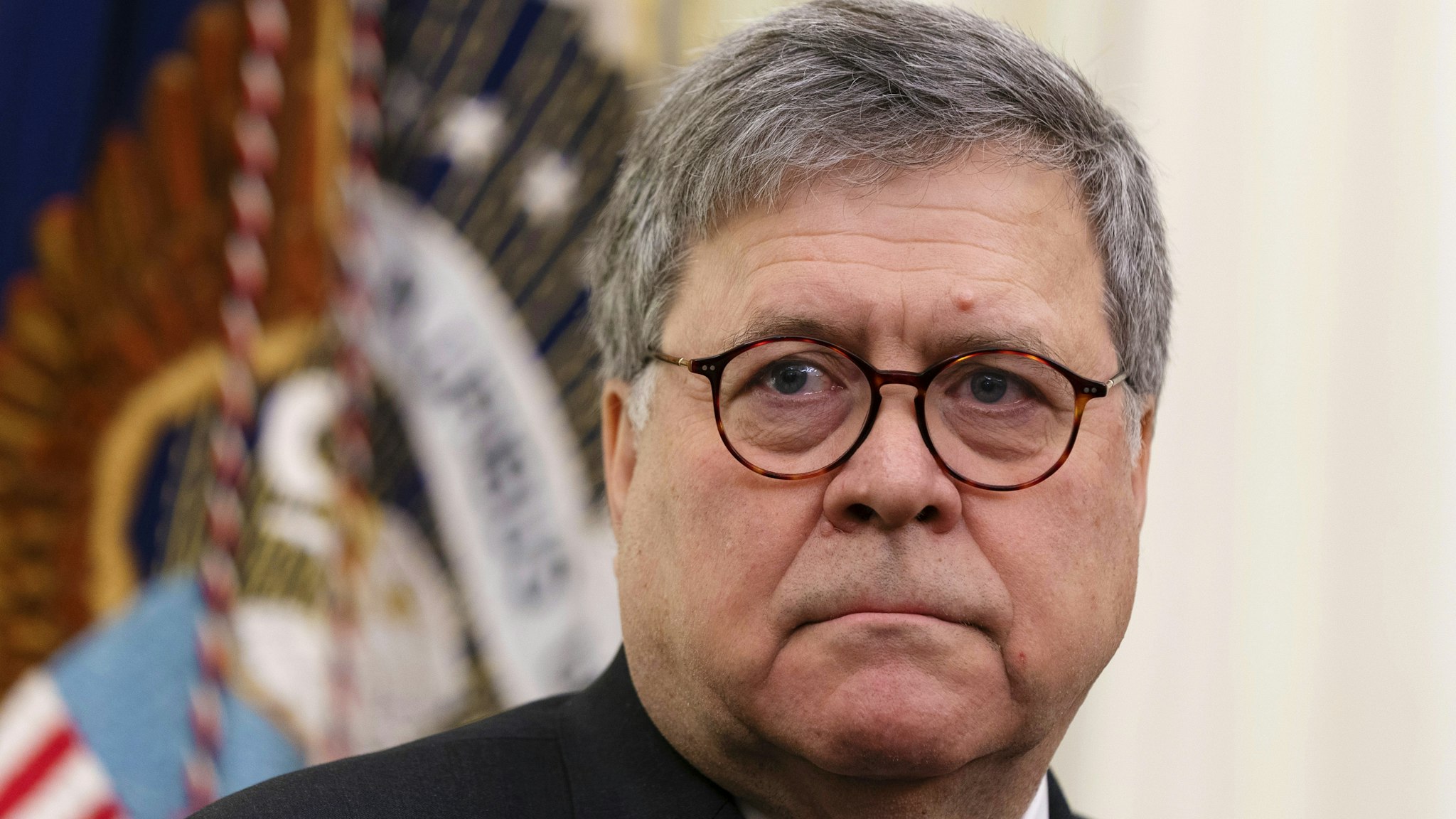William Barr, U.S. attorney general, watches while U.S. President Donald Trump, not pictured, signs an executive order establishing a task force on missing and murdered American Indians and Alaska Natives in the Oval Office of the White House in Washington, D.C., U.S., on Tuesday, Nov. 26, 2019. The task force is meant to engage with tribal communities on the scope of the issue and to develop protocols to apply to new and unsolved cases.