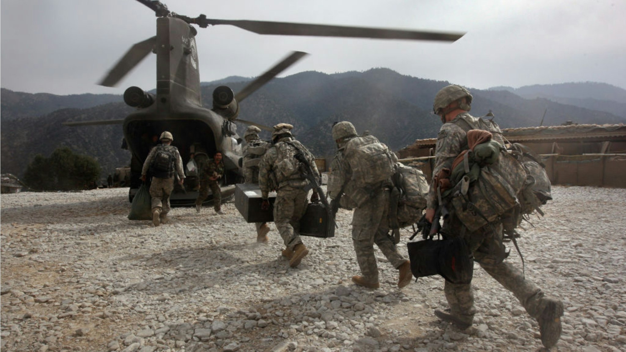 U.S. soldiers board an Army Chinook transport helicopter after it brought fresh soldiers and supplies to the Korengal Outpost on October 27, 2008 in the Korengal Valley, Afghanistan.