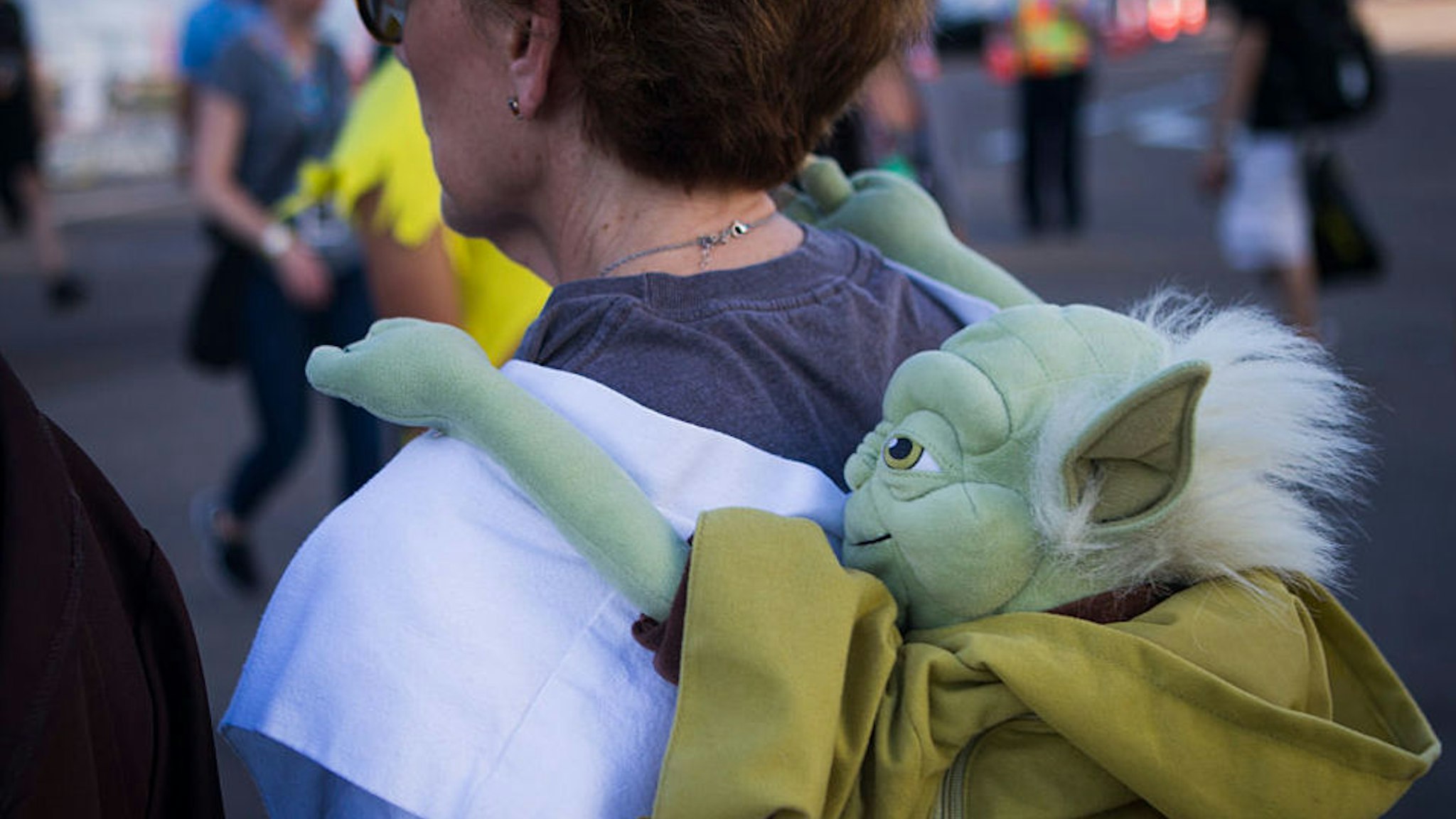SAN DIEGO, CA --JULY 21, 2016-- A woman wears Yoda on her back during the second day of Comic-Con 2016, in San Diego, July 21, 2016.