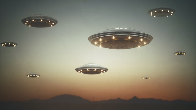 Invasion of alien spaceships at sunset, illustration.