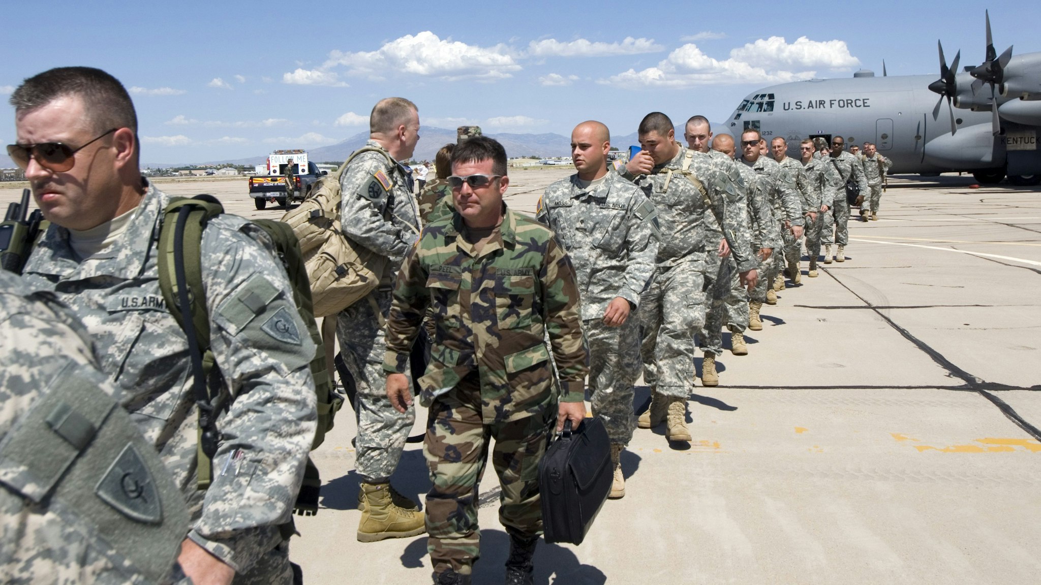 TUCSON, AZ - JULY 11: Members of the Kentucky National Guard 206th Engineer battalion arrive on a C-130 Hercules transport plane July 11, 2006 in Tucson, Arizona. One hundred members of the unit are here in support of Border Patrol agents maintaining the U.S./Mexican border. The two-week mission is part of President Bush's Operation Jump Start, which calls for 700 National Guard troops from around the country to help in securing the border in Arizona. The Kentucky Guard?s mission will be to build roads, fences and temporary vehicle barriers throughout the Tucson and Yuma sectors of the border.