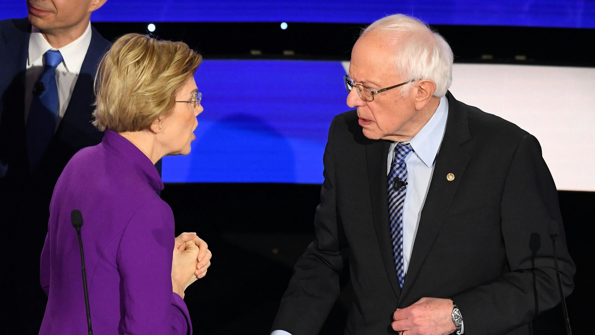 Democratic presidential hopeful Massachusetts Senator Elizabeth Warren and Vermont Senator Bernie Sanders speak after the seventh Democratic primary debate of the 2020 presidential campaign season co-hosted by CNN and the Des Moines Register at the Drake University campus in Des Moines, Iowa on January 14, 2020.