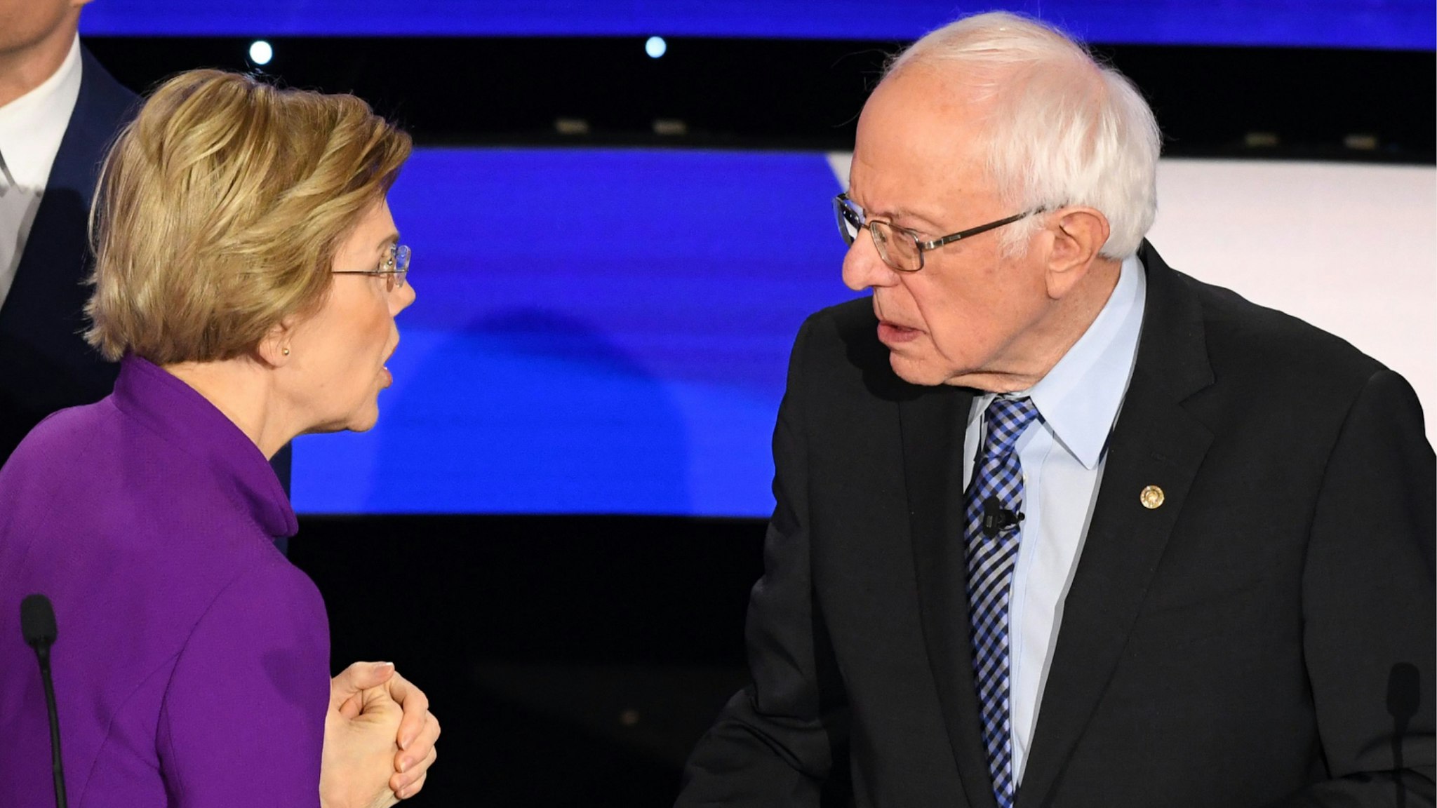 Democratic presidential hopeful Massachusetts Senator Elizabeth Warren and Vermont Senator Bernie Sanders speak after the seventh Democratic primary debate of the 2020 presidential campaign season co-hosted by CNN and the Des Moines Register at the Drake University campus in Des Moines, Iowa on January 14, 2020.