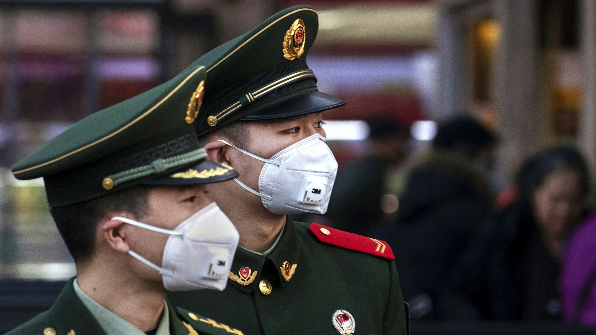 BEIJING, CHINA - JANUARY 22: Chinese police officers wear protective masks at Beijing Station before the annual Spring Festival on January 22, 2020 in Beijing, China. The number of cases of a deadly new coronavirus rose to over 400 in mainland China Wednesday as health officials stepped up efforts to contain the spread of the pneumonia-like disease which medicals experts confirmed can be passed from human to human. The number of those who have died from the virus in China climbed to nine on Wednesday and cases have been reported in other countries including the United States,Thailand, Japan, Taiwan and South Korea.