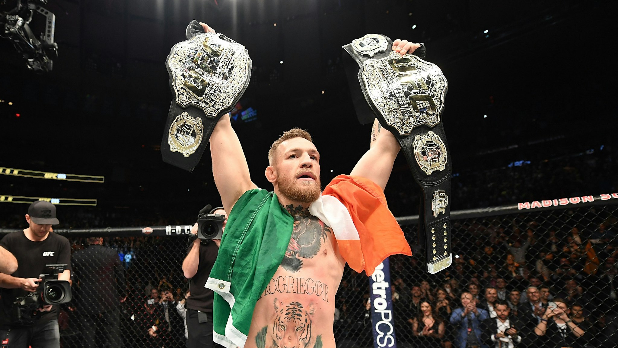 NEW YORK, NY - NOVEMBER 12: UFC lightweight and featherweight champion Conor McGregor of Ireland celebrates after defeating Eddie Alvarez in their UFC lightweight championship fight during the UFC 205 event at Madison Square Garden on November 12, 2016 in New York City.