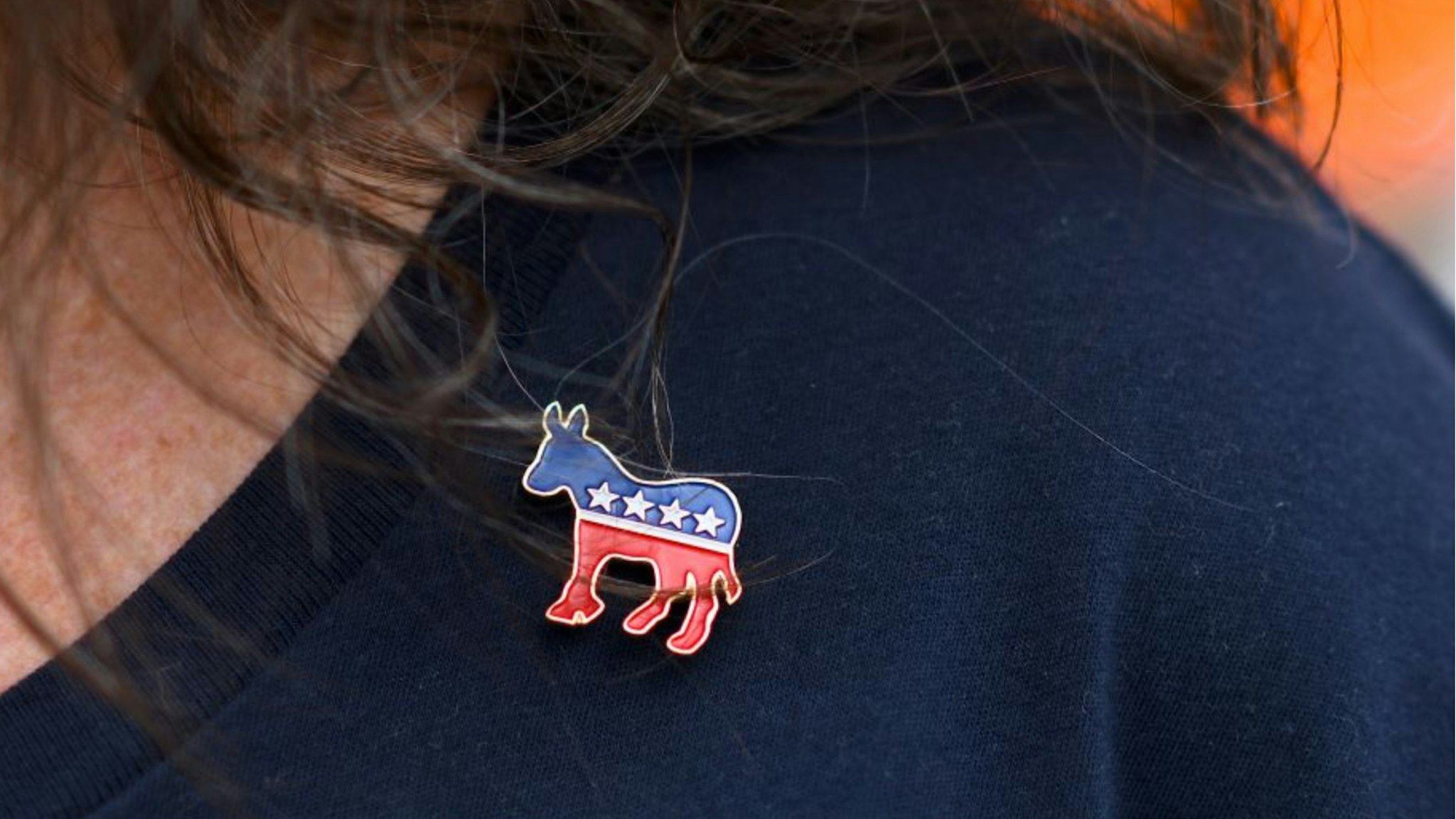 Donna Elms wears a Democrat donkey pin while lining up outside in advance of a campaign rally with former President Barack Obama, Pennsylvania Governor Tom Wolf, and Senator Bob Casey (D- PA) on September 21, 2018 in Philadelphia, Pennsylvania.