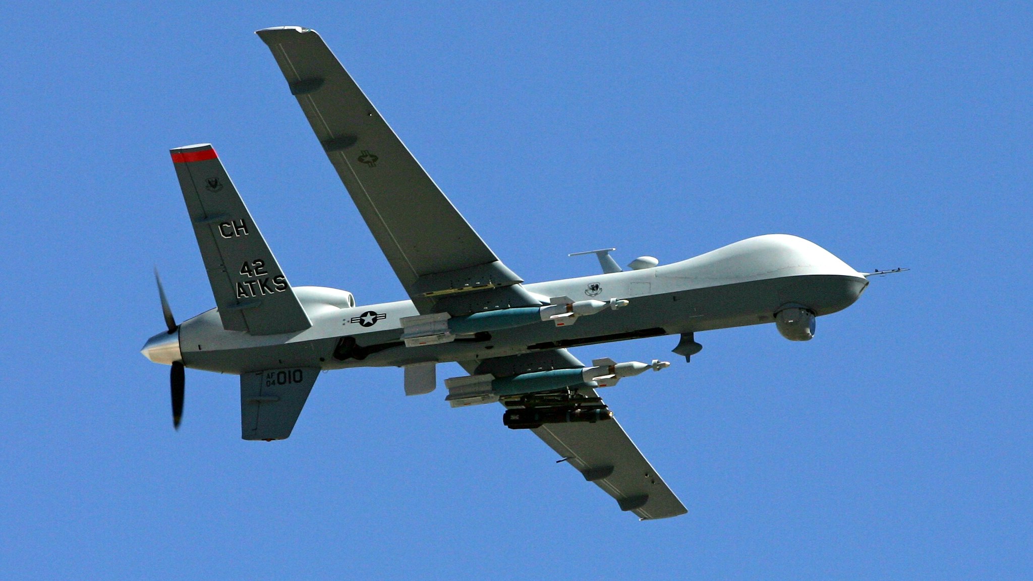 CREECH AIR FORCE BASE, NV - AUGUST 08: An MQ-9 Reaper flies by August 8, 2007 at Creech Air Force Base in Indian Springs, Nevada. The Reaper is the Air Force's first "hunter-killer" unmanned aerial vehicle (UAV), designed to engage time-sensitive targets on the battlefield as well as provide intelligence and surveillance. The jet-fighter sized Reapers are 36 feet long with 66-foot wingspans and can fly for up to 14 hours fully loaded with laser-guided bombs and air-to-ground missiles. They can fly twice as fast and high as the smaller MQ-1 Predators, reaching speeds of 300 mph at an altitude of up to 50,000 feet. The aircraft are flown by a pilot and a sensor operator from ground control stations. The Reapers are expected to be used in combat operations by the U.S. military in Afghanistan and Iraq within the next year.