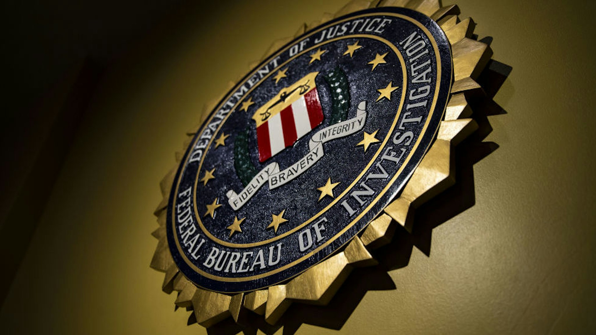 The seal of the Federal Bureau of Investigation (FBI) hangs on a wall before a news conference at the FBI headquarters in Washington, D.C., U.S., on Thursday, June 14, 2018.
