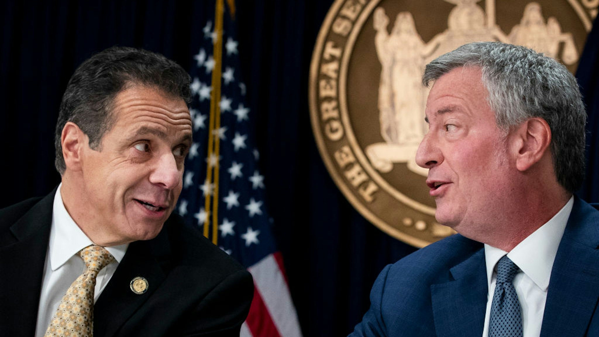 New York Governor Andrew Cuomo and New York City Mayor Bill de Blasio talk with each other during a press conference to discuss Amazon's decision to bring a new corporate location to New York City, November 13, 2018 in New York City.
