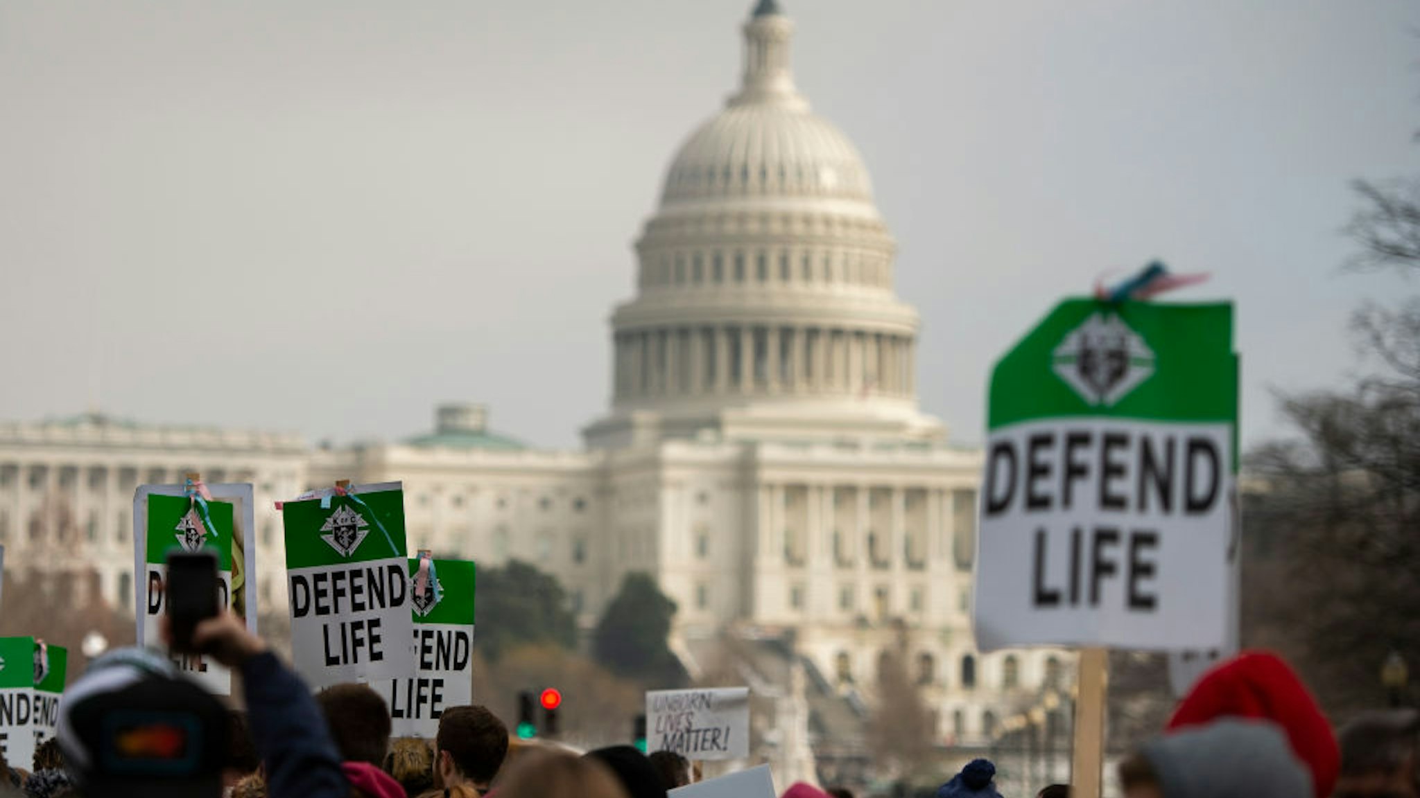 Students and activists carry signs during the annual "March for Life" in Washington, DC on January 18, 2019.