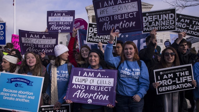 Pro-life demonstrators hold signs outside of the U.S. Supreme Court during the 46th annual March for Life in Washington, D.C., U.S., on Jan. 18, 2019.