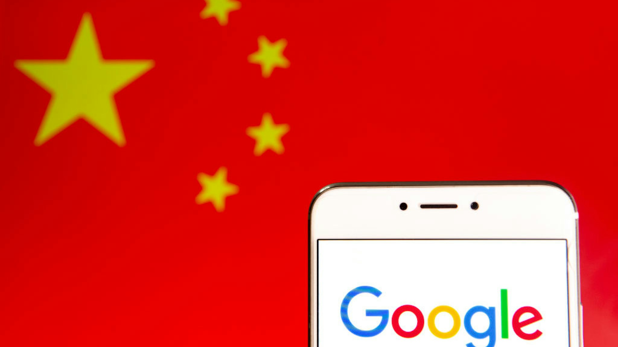 In this photo illustration a logo of the American multinational technology company and search engine Google is seen on an Android mobile device with People's Republic of China flag in the background.