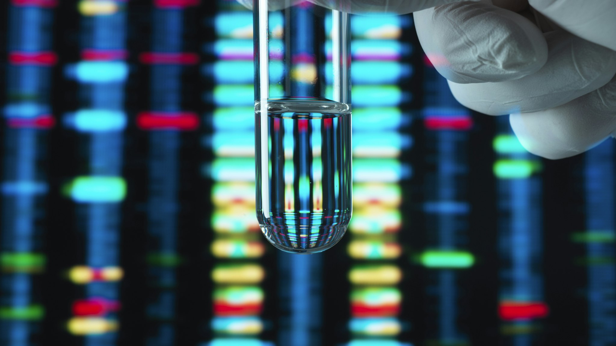Genetic Research, DNA profile reflected in a test tube containing a sample - stock photo