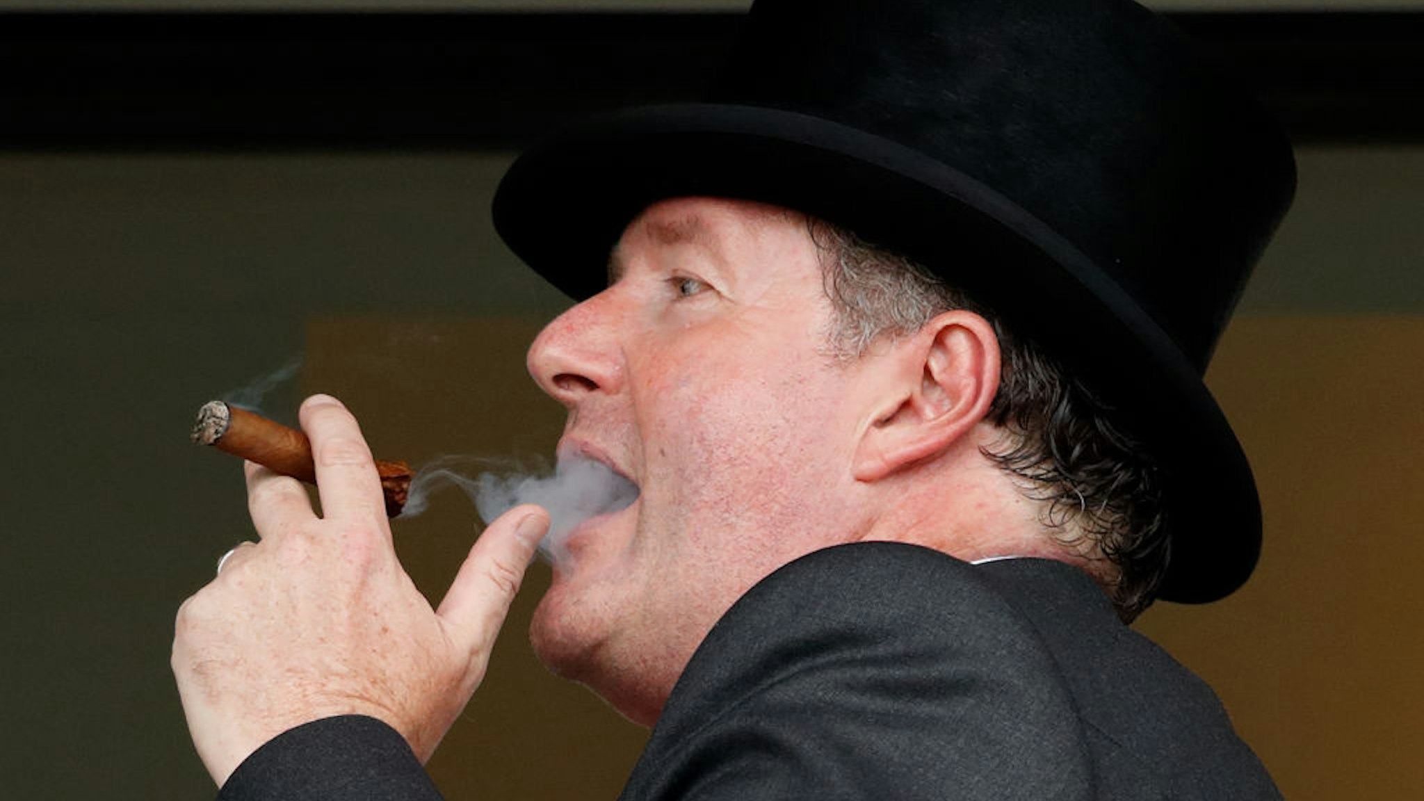 Piers Morgan smokes a cigar whilst watching the racing on day two of Royal Ascot at Ascot Racecourse on June 19, 2019 in Ascot, England.