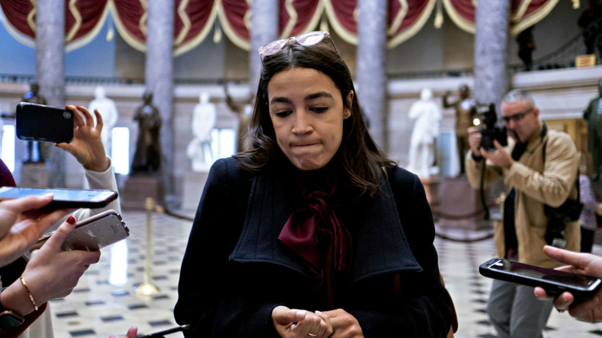 Representative Alexandria Ocasio-Cortez, a Democrat from New York, pauses while speaking to members of the media in Statuary Hall of the U.S. Capitol in Washington, D.C., U.S., on Wednesday, Dec. 18, 2019.