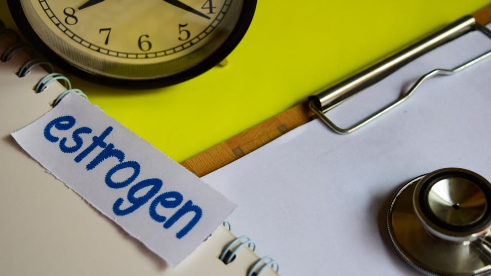 High Angle View Of Clock By Clipboard Against Yellow Background estrogen