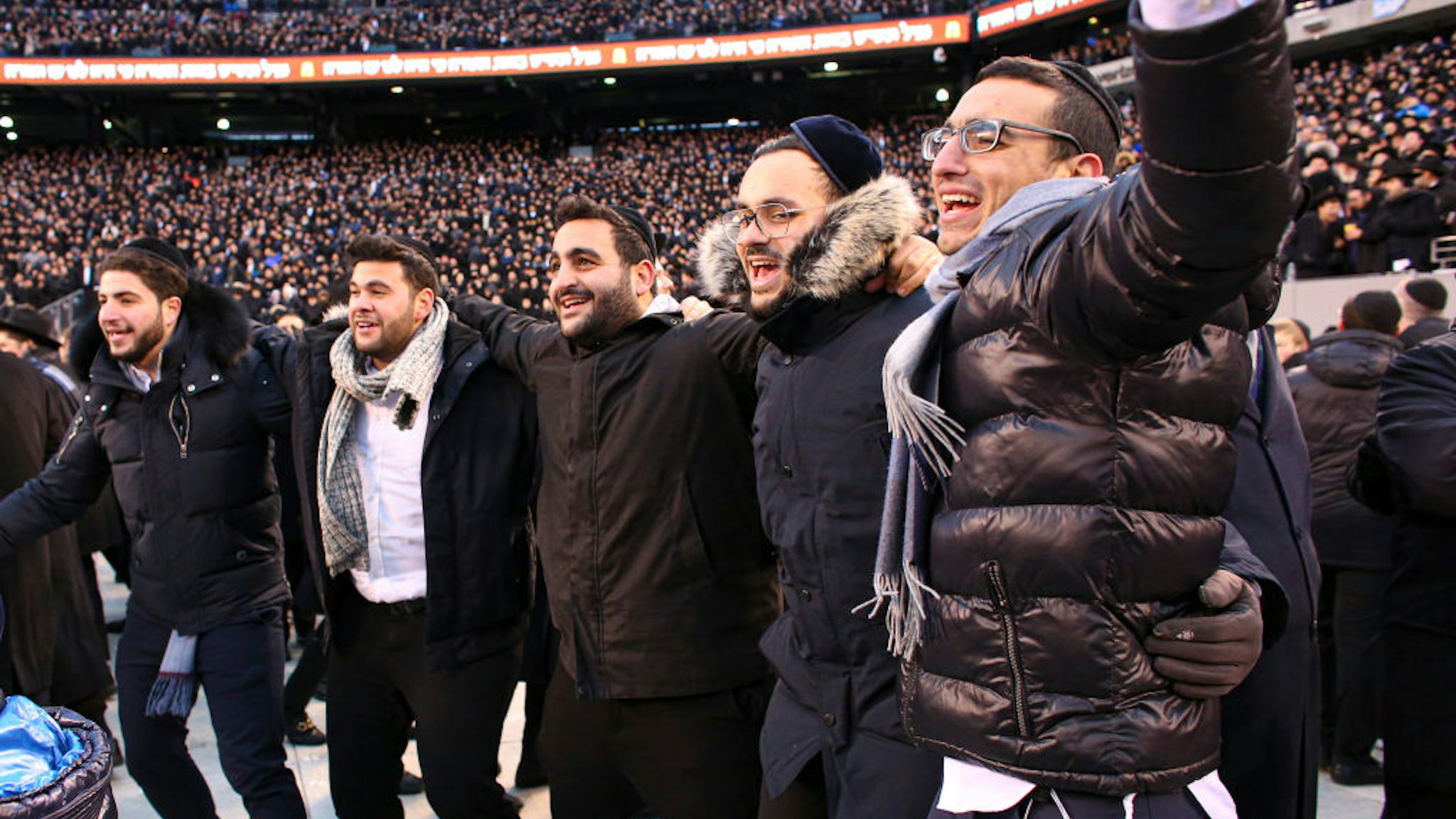 Men dance as they celebrate Siyum HaShas, the completion of the reading of the Babylonian Talmud, at the MetLife Stadium on January 1, 2020, in East Rutherford, New Jersey.