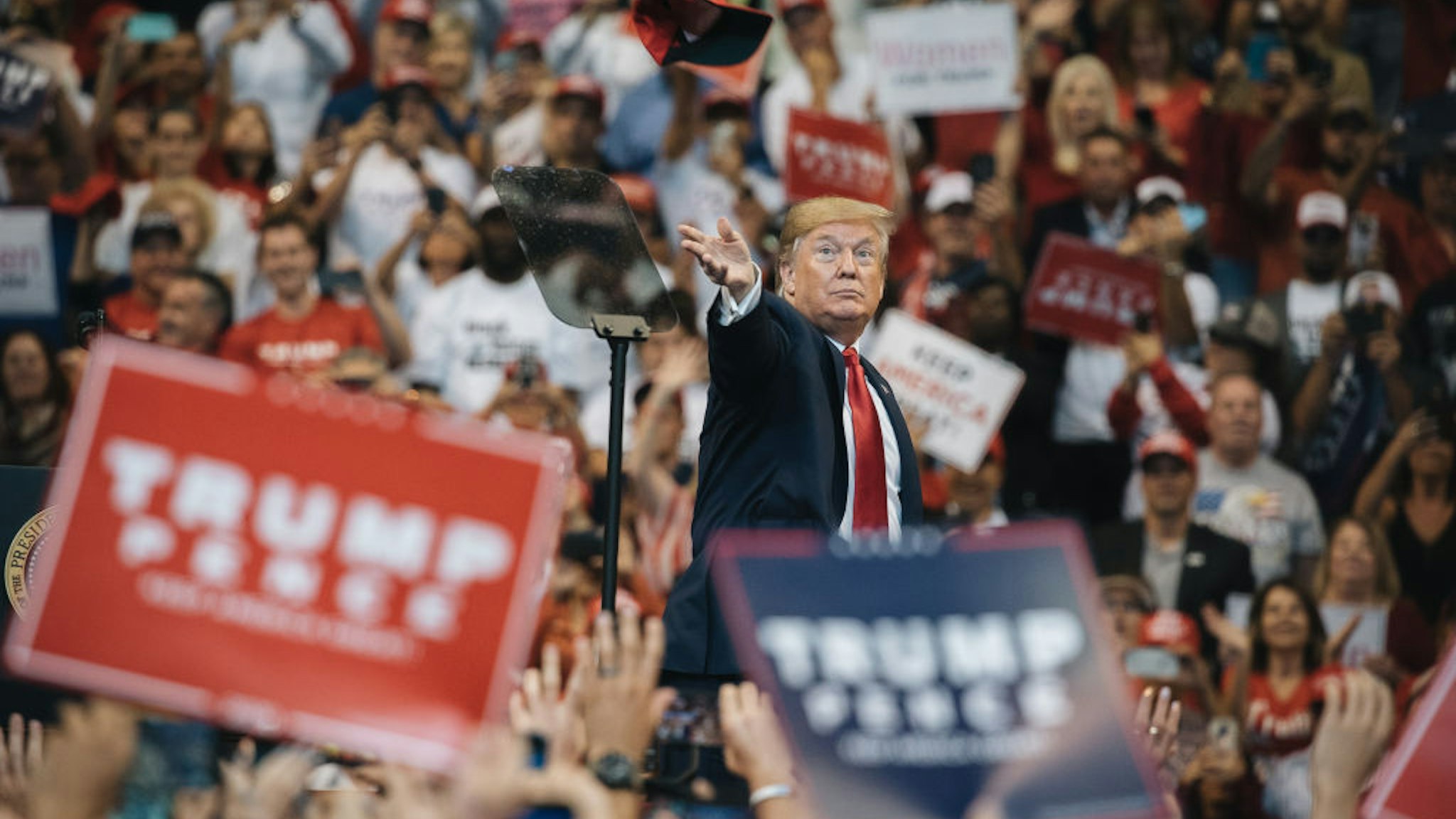 President Donald Trump throws a hat to the crowd during a 'Homecoming' rally in Sunrise, Florida, U.S., on Tuesday, Nov. 26, 2019. Monday, January 20, 2020, marks the third anniversary of U.S. President Donald Trump's inauguration.