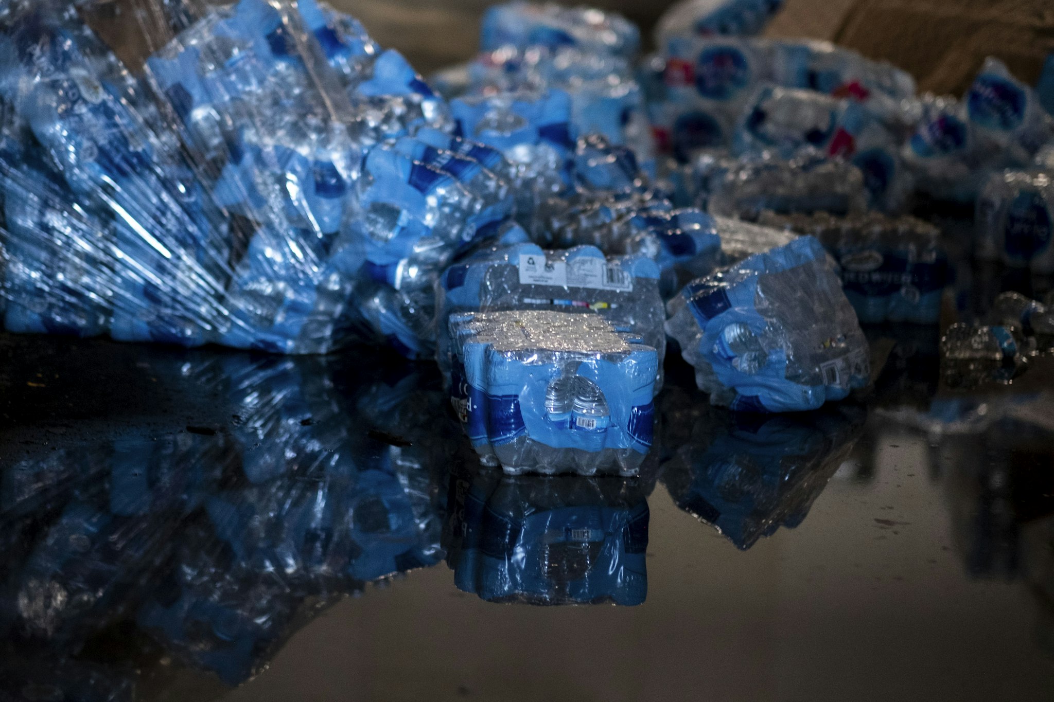 Bottled water believed to have been from when Hurricane Maria struck the island in 2017 is seen in a warehouse in Ponce, Puerto Rico on January 18, 2020, after a powerful earthquake hit the island. - President Donald Trump on January 16 freed up emergency aid for Puerto Rico's recovery from a January 7 earthquake that caused widespread disruption and damage on the island. Trump's declaration of a major disaster in Puerto Rico makes federal funding available for repairs, temporary housing and low-cost loans "to help individuals and business owners recover from the effects of the disaster," the White House said. (Photo by Ricardo ARDUENGO / AFP) (Photo by RICARDO ARDUENGO/AFP via Getty Images)