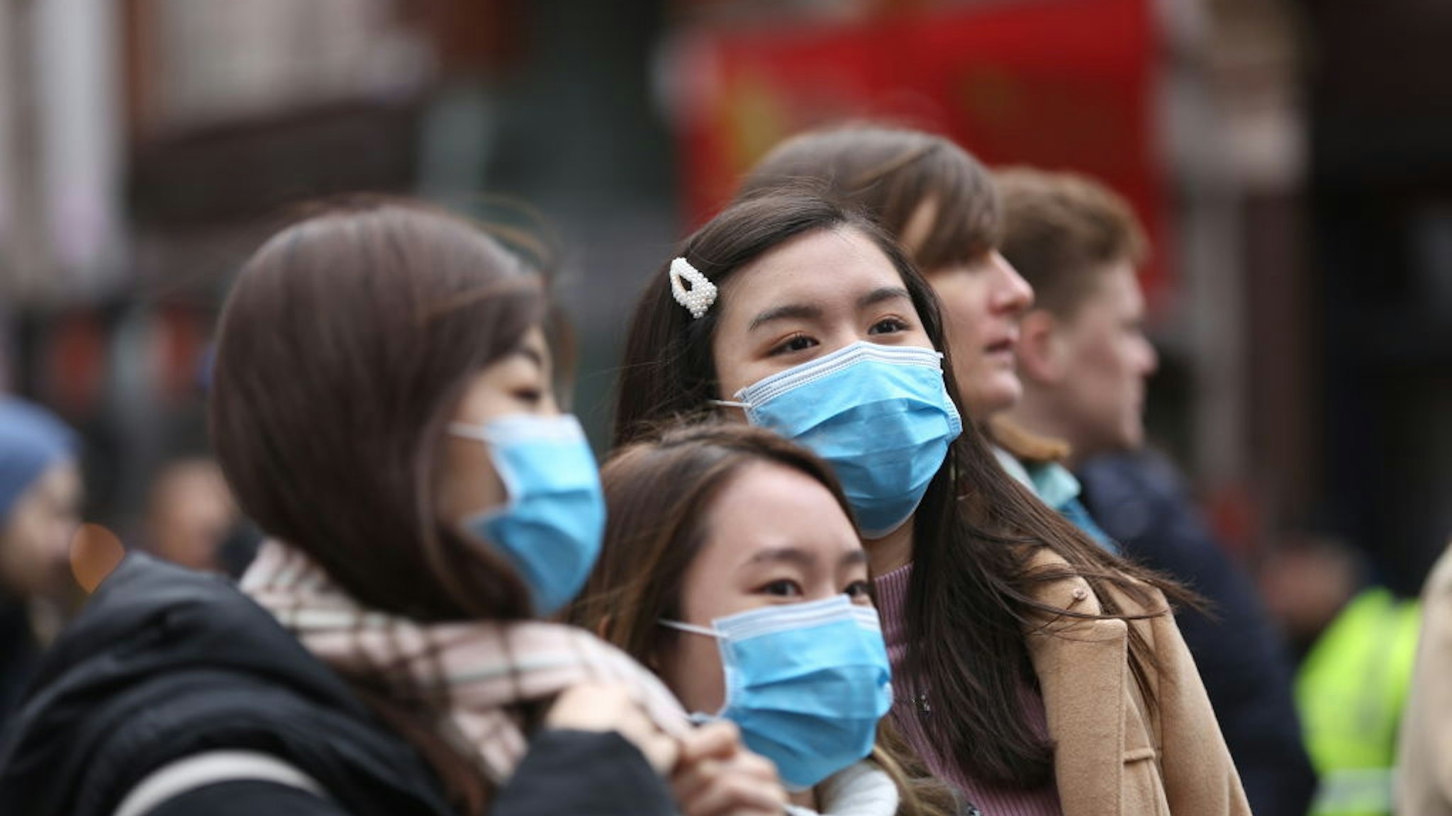 London Chinatown entered the Chinese new year ("year of the rat") in the shadow of coronavirus with pedestrians covering their faces with sanitary masks but celebrations went on in London, England on January 26, 2020.