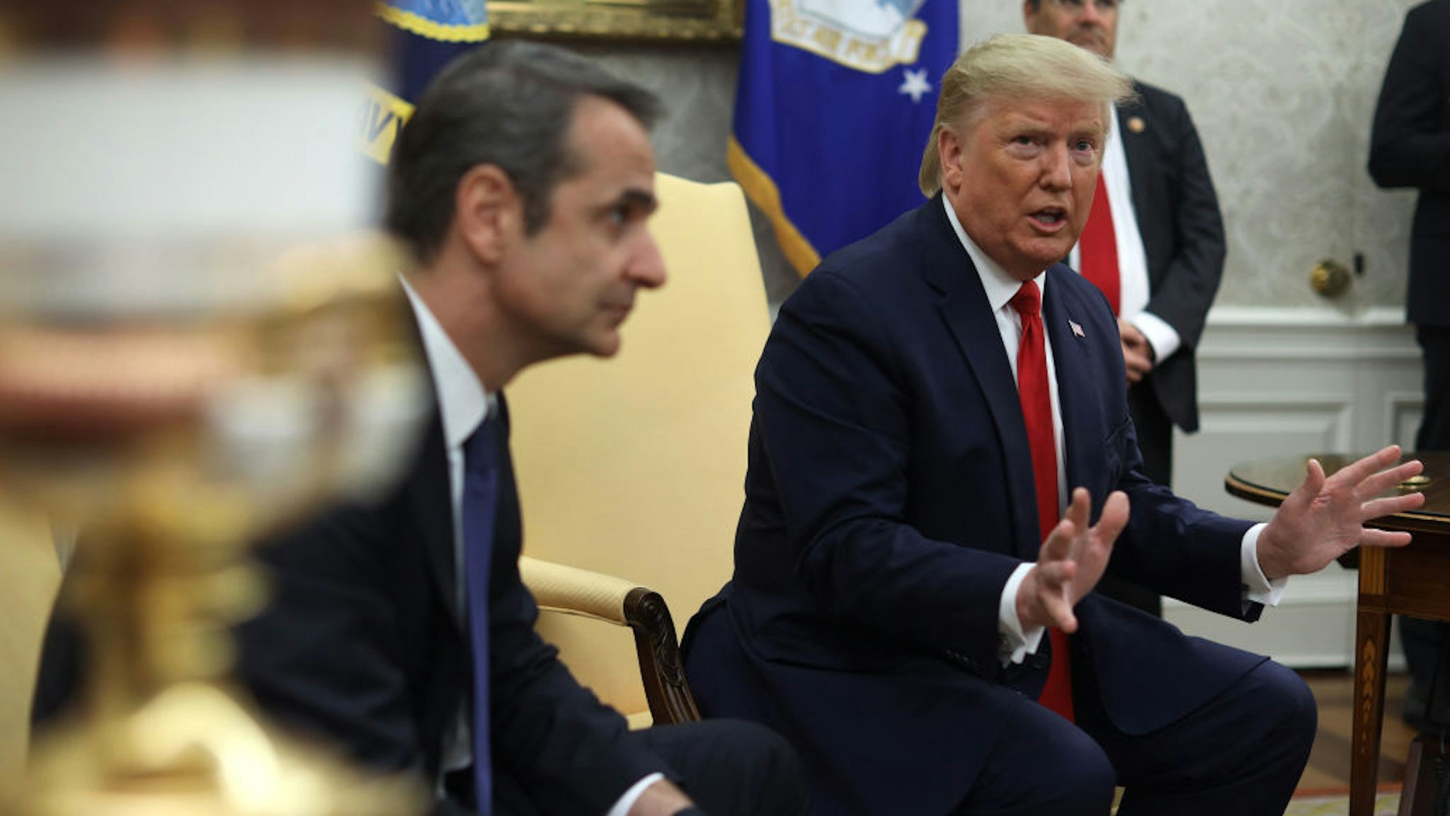 U.S. President Donald Trump speaks to members of the media as Prime Minister of Greece Kyriakos Mitsotakis listens during a meeting in the Oval Office of the White House January 7, 2020 in Washington, DC.