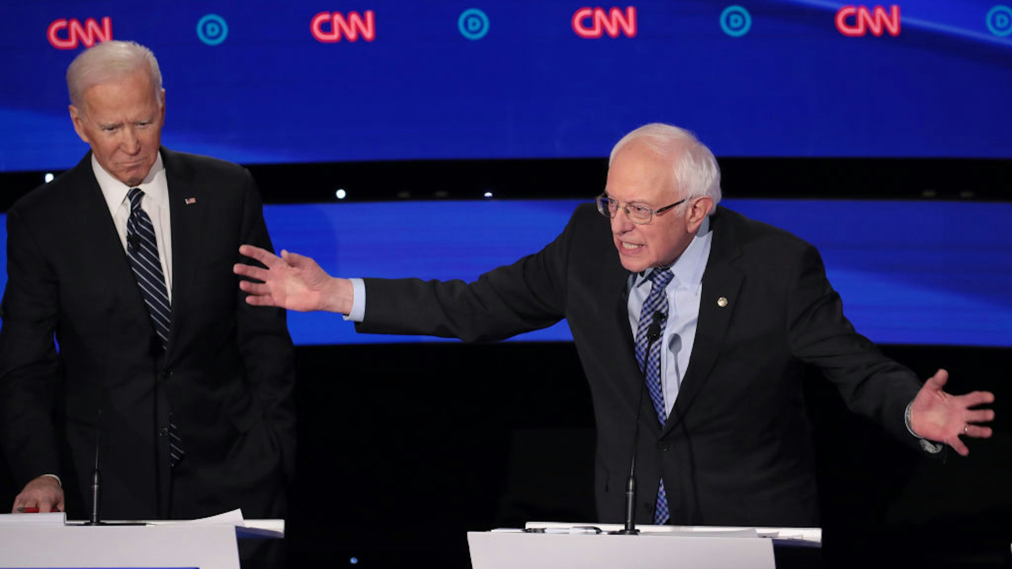 Former Vice President Joe Biden (L) listens as Sen. Bernie Sanders (I-VT) makes a point during the Democratic presidential primary debate at Drake University on January 14, 2020 in Des Moines, Iowa.