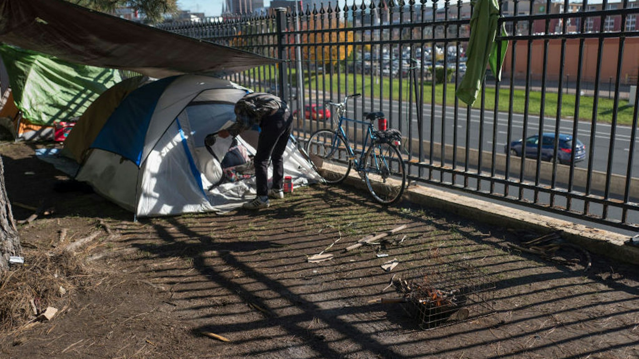 A homeless man who did not want his named used made coffee near his tent at the homeless encampment