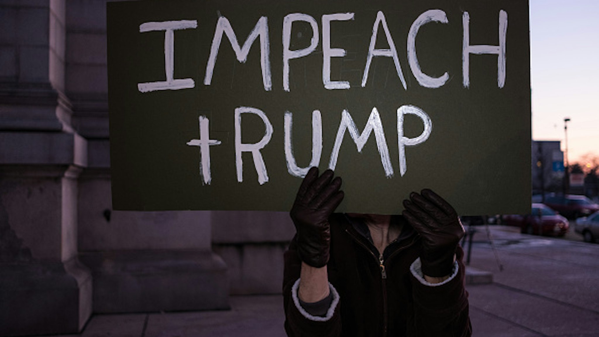 DAYTON, OHIO, UNITED STATES - 2019/12/17: A protester holds an Impeach Trump placard during a Trump pro-impeachment rally in Dayton. The protesters gathered in Dayton to show their support for Trumps impeachment the day before the House vote.