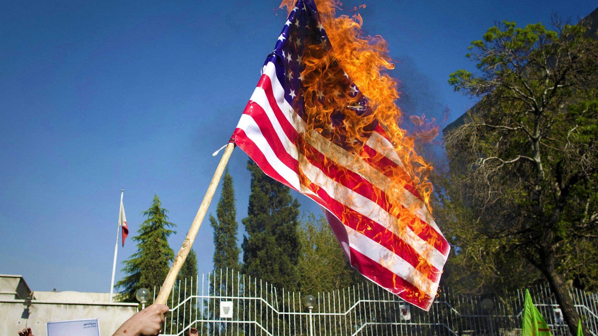 Iranian hardline students burn a US flag during a demonstration against the Bahraini government's suppression of protests led by the mainly-Shiite opposition in the kingdom outside the Bahraini embassy in Tehran on April 15, 2011 as Iran has demanded intervention from the United Nations Security Council "to stop the killing of the people of Bahrain".