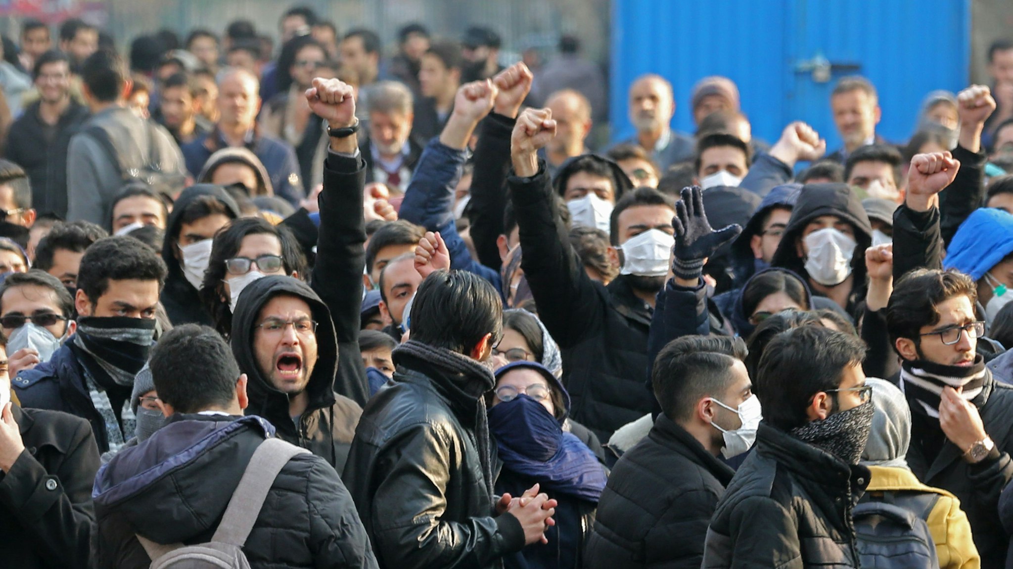 Iranian students gather for a demonstration over the downing of a Ukrainian airliner at Tehran University on January 14, 2020. - AFP correspondents said around 200 mainly masked students gathered at Tehran University and were locked in a tense standoff with youths from the Basij militia loyal to the establishment."Death to Britain," women clad in black chadours chanted as Basij members burned a cardboard cutout of the British ambassador to Tehran, Rob Macaire, after his brief arrest for allegedly attending a demonstration Saturday. Kept apart by security forces, the groups eventually parted ways.