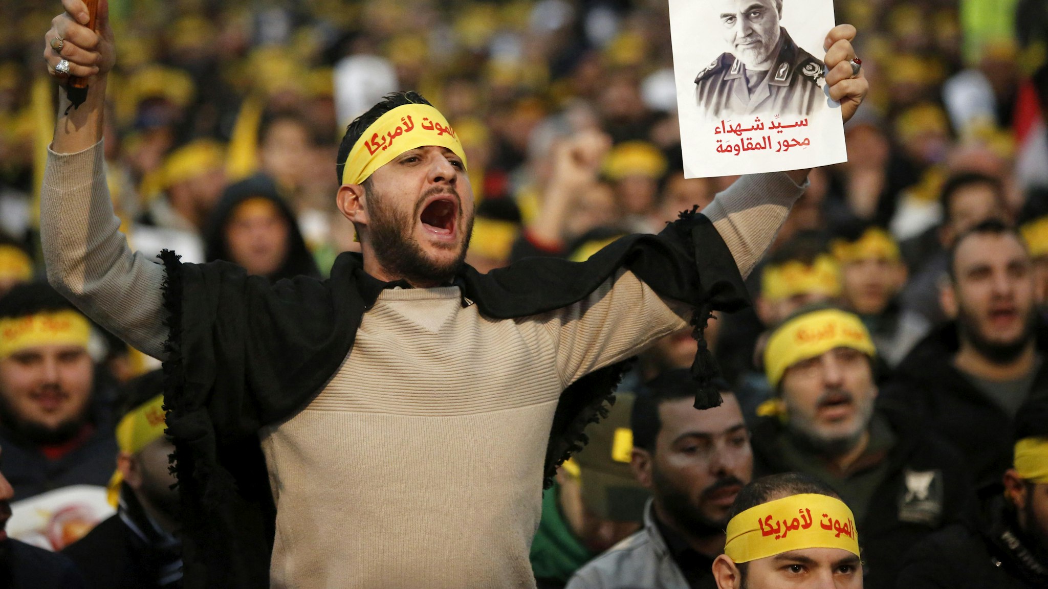 BEIRUT, Jan. 5, 2020 -- Supporters shout slogans during a rally for Qassem Soleimani in southern suburbs of Beirut, Lebanon, on Jan. 5, 2020. Hezbollah leader Sayyed Hassan Nasrallah urged on Sunday its fighters to attack U.S. soldiers in the region in retaliation for the assassination of Iranian top commander Qassem Soleimani by the United States.