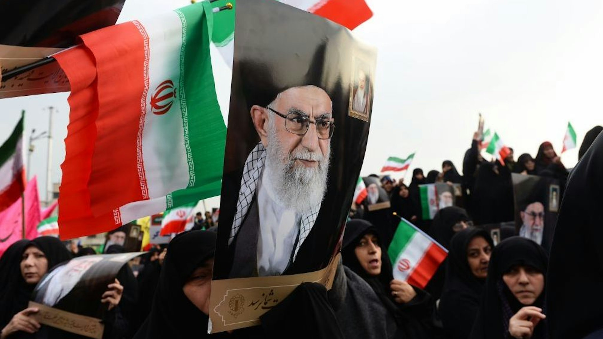Demonstrators hold posters of Iranian Supreme Leader Ayatollah Ali Khamenei during a pro-government demonstration to react to protests due to fuel price increase of Iran, on November 25, 2019 in Tehran, Iran. (Photo by Fatemeh Bahrami/Anadolu Agency via Getty Images)
