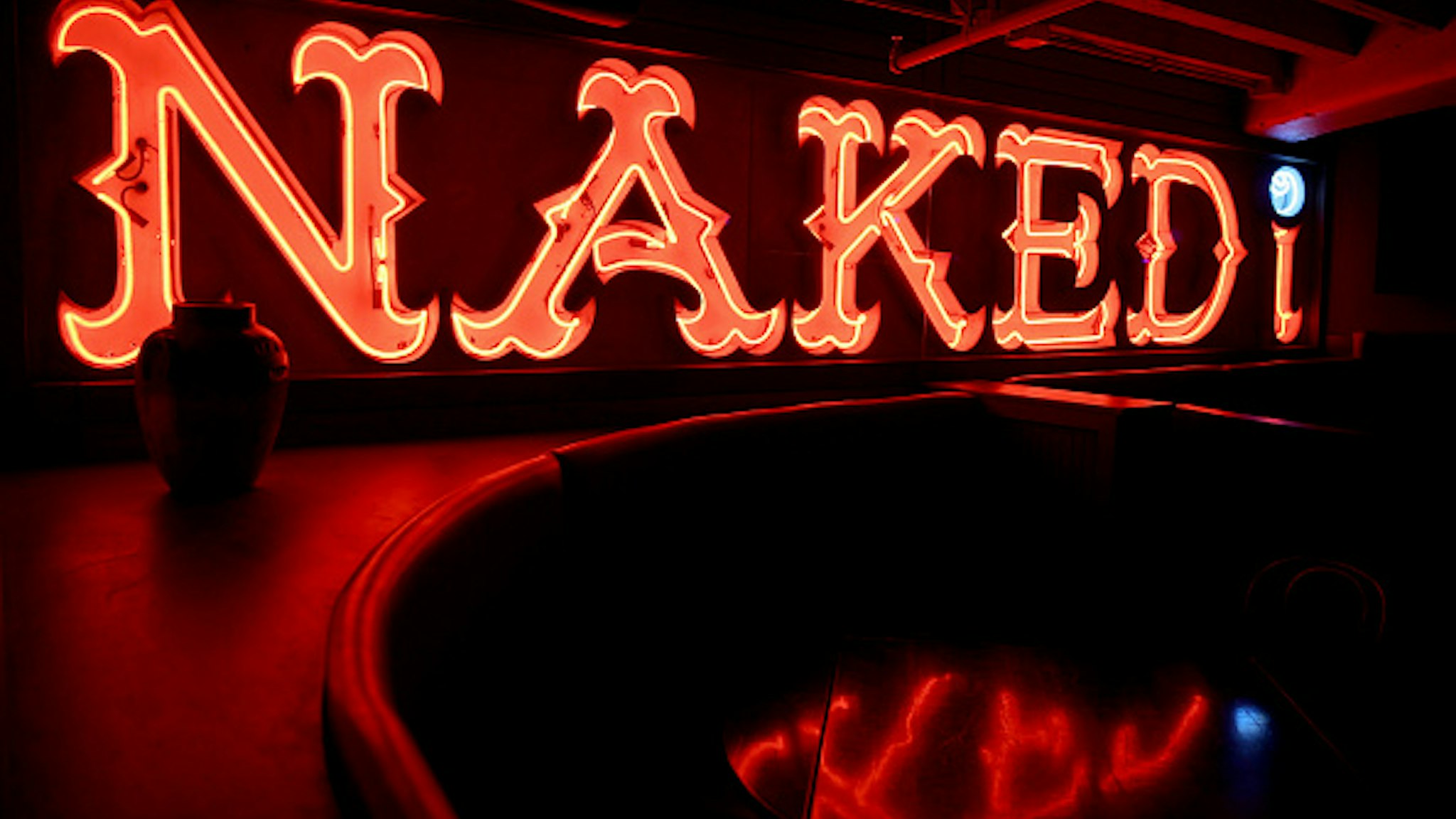 BOSTON - JULY 21: The former Naked i strip club sign hangs in the lower level of West End Johnnie's in Boston. The Naked i was one of many venues in the former "Combat Zone" adult entertainment district.