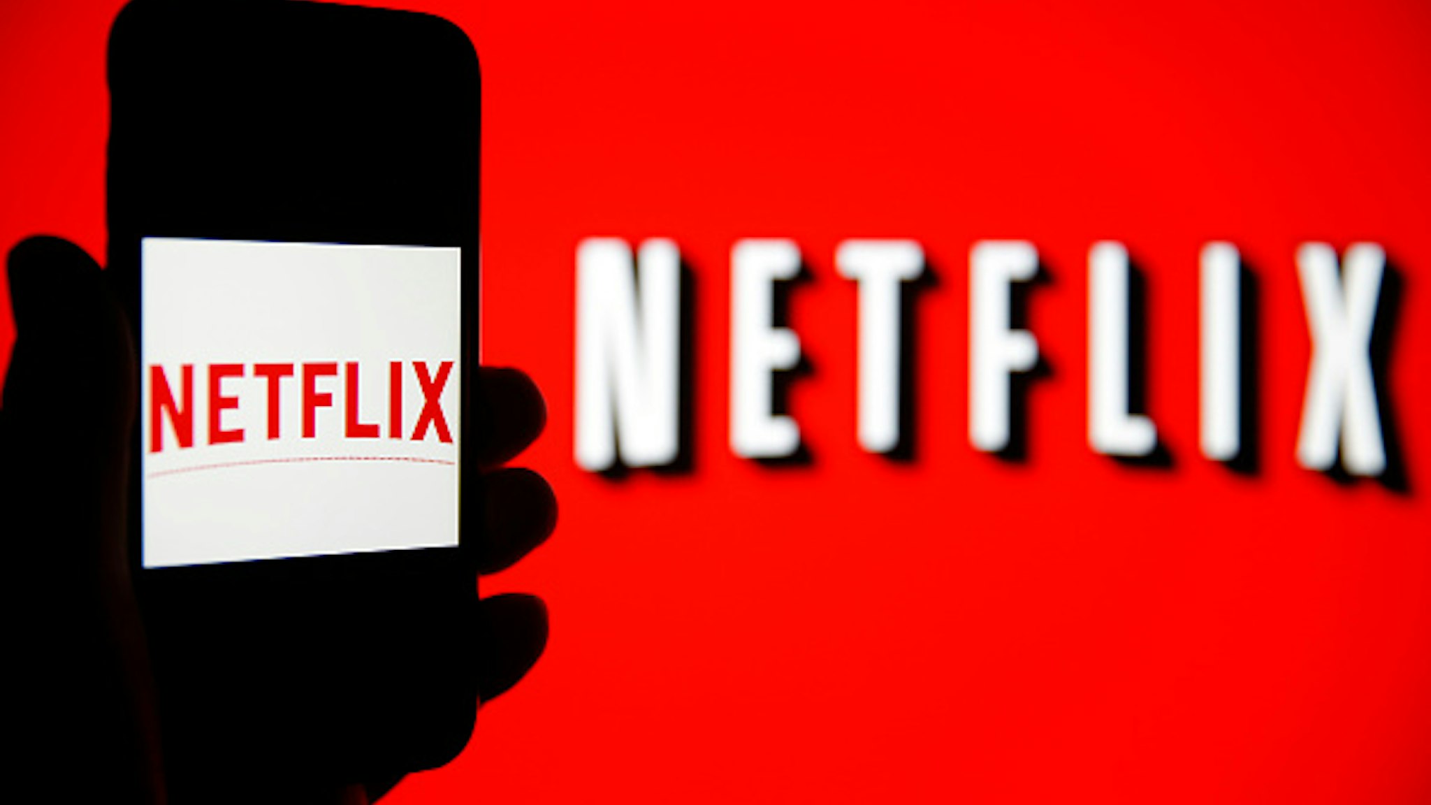 PARIS, FRANCE - FEBRUARY 13: In this photo iIllustration, the Netflix logo is seen on the screen of an iPhone in front of a computer screen showing a Netflix logo on February 13, 2019 in Paris, France. Netflix, the US giant of online video subscription, has more than 5 million subscribers in France, 4 and a half years after its arrival in France in September 2014, a spokesman for the company revealed on Wednesday. Netflix offers movies and TV series over the internet and now has 137 million subscribers worldwide.