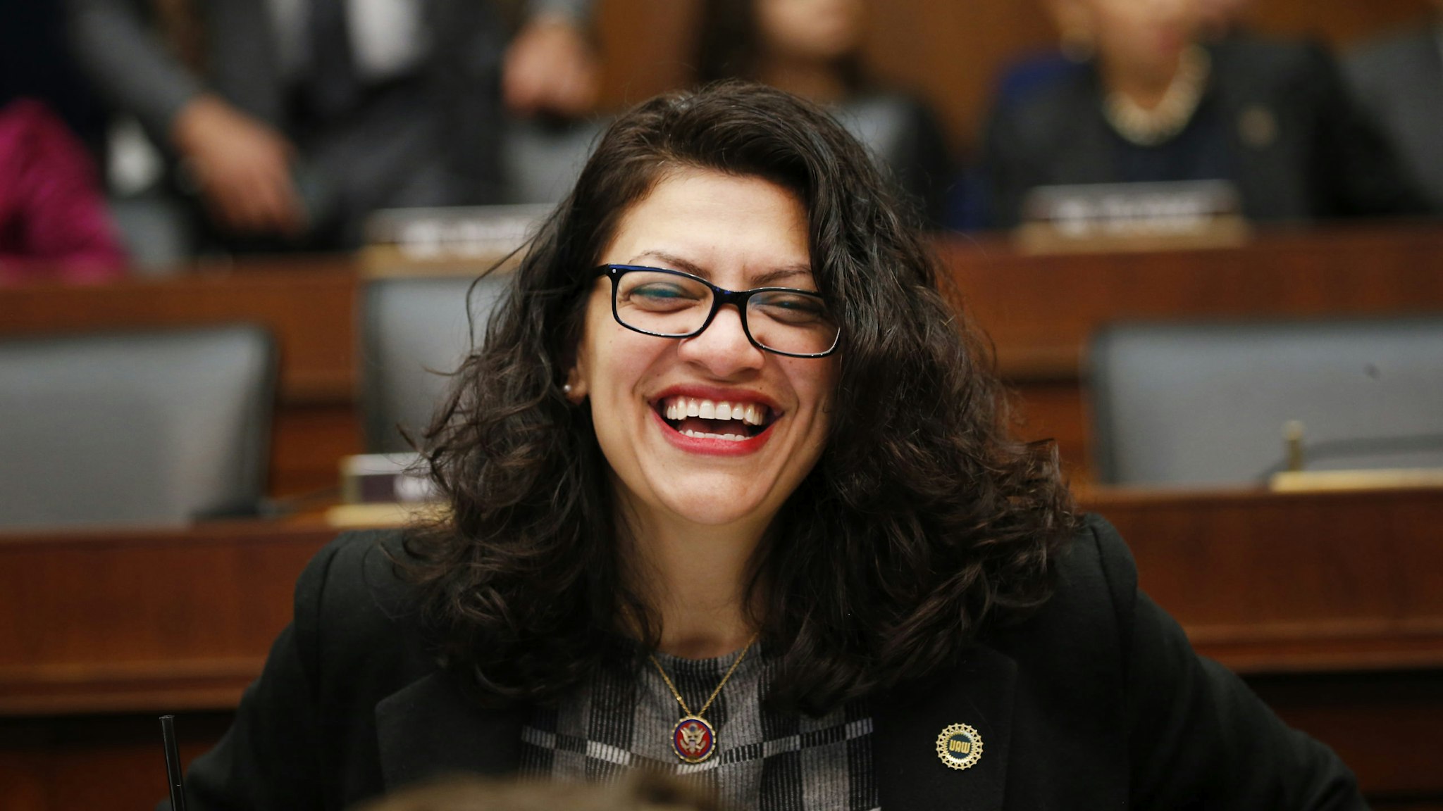 Representative Rashida Tlaib, a Democrat from Michigan, smiles before the start of a House Financial Services Committee hearing with Mark Zuckerberg, chief executive officer and founder of Facebook Inc., in Washington, D.C., U.S., on Wednesday, Oct. 23, 2019. Despite spending record amounts of money to influence Washington policy, Facebook's efforts to ingratiate itself so far have done little to assuage policy makers' privacy and antitrust concerns and in some cases have even made the company's challenges worse, according to first-hand accounts of its efforts.