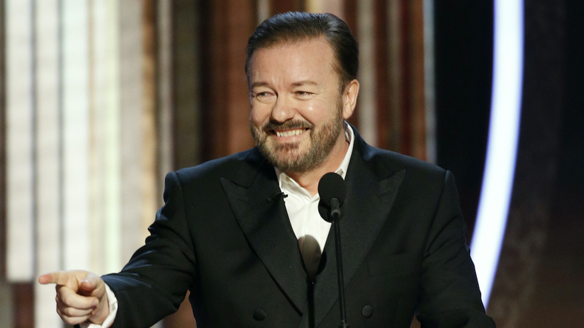 n this handout photo provided by NBCUniversal Media, LLC, host Ricky Gervais speaks onstage during the 77th Annual Golden Globe Awards at The Beverly Hilton Hotel on January 5, 2020 in Beverly Hills, California. (Photo by Paul Drinkwater/NBCUniversal Media, LLC via Getty Images)