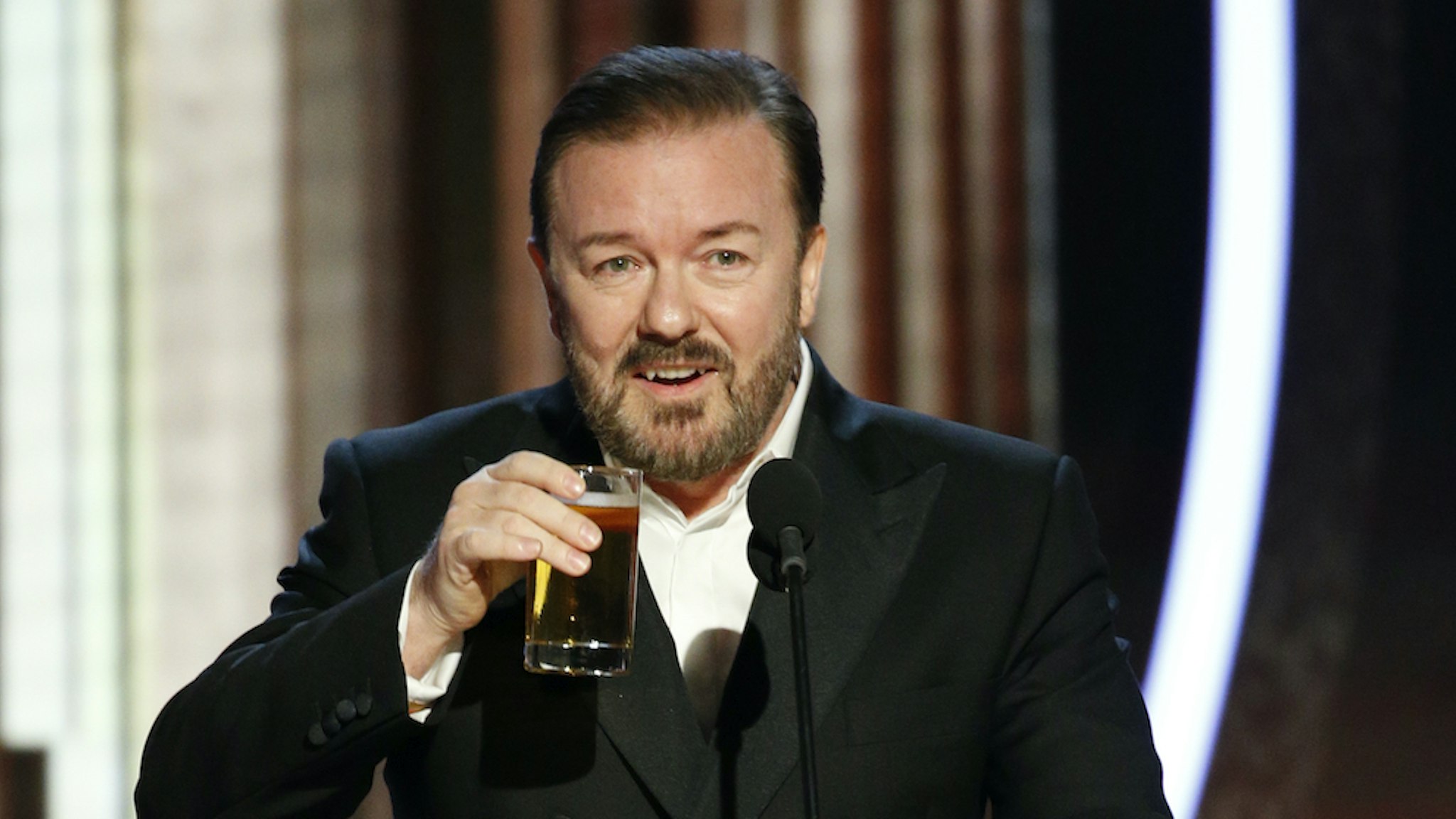 In this handout photo provided by NBCUniversal Media, LLC, host Ricky Gervais speaks onstage during the 77th Annual Golden Globe Awards at The Beverly Hilton Hotel on January 5, 2020 in Beverly Hills, California. (Photo by Paul Drinkwater/NBCUniversal Media, LLC via Getty Images)