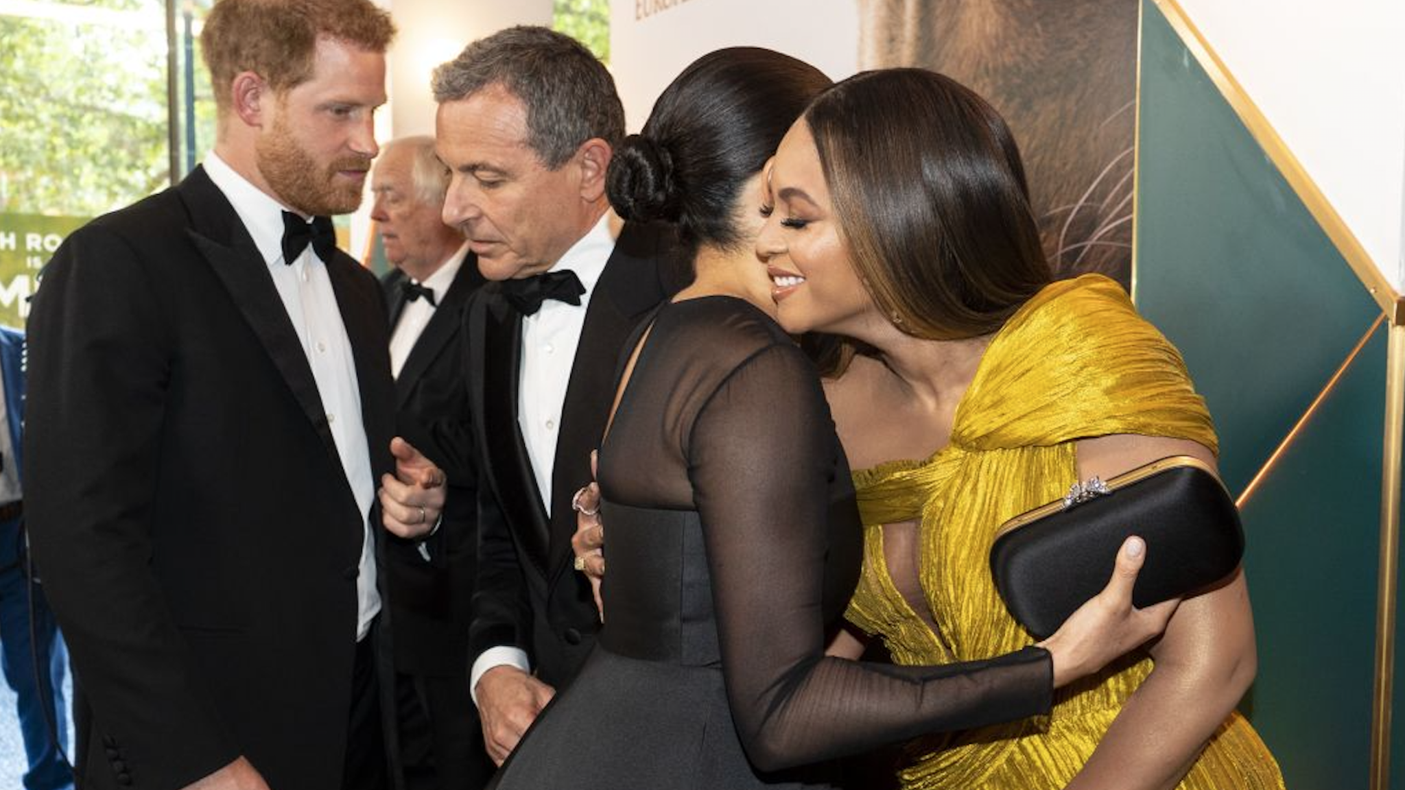 Britain's Prince Harry, Duke of Sussex (L) chats with Disney CEO Robert Iger as Britain's Meghan, Duchess of Sussex (2nd R) embraces US singer-songwriter Beyoncé (R) as they attend the European premiere of the film The Lion King in London on July 14, 2019.
