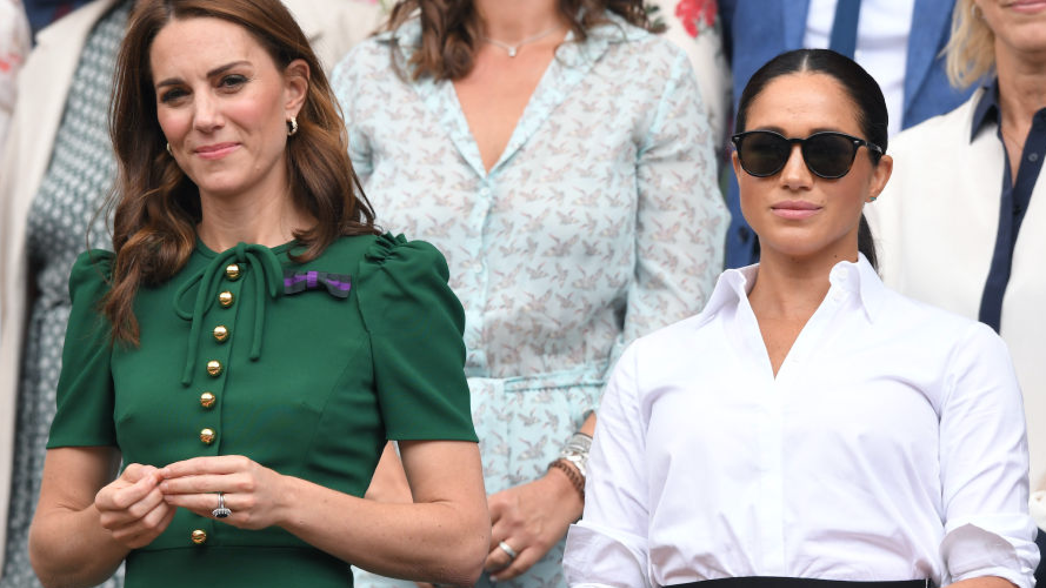 Catherine, Duchess of Cambridge and Meghan, Duchess of Sussex in the Royal Box on Centre Court during day twelve of the Wimbledon Tennis Championships at All England Lawn Tennis and Croquet Club on July 13, 2019 in London, England.