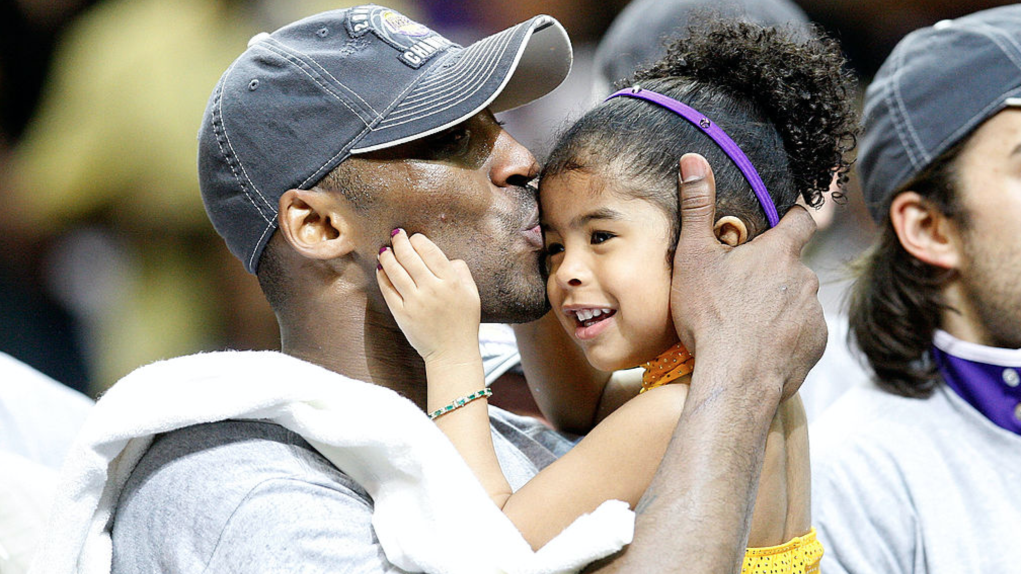 Kobe Bryant #24 of the Los Angeles Lakers kisses his daughter, Gianna, after the Lakers defeated the Orlando Magic 99-86 in Game Five of the 2009 NBA Finals on June 14, 2009 at Amway Arena in Orlando, Florida.