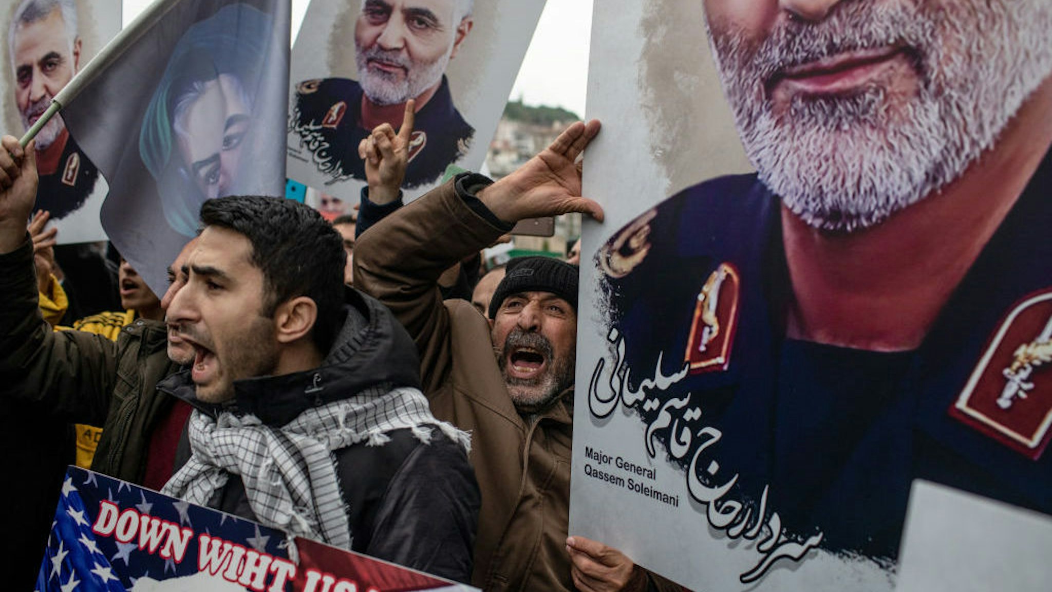 People hold posters showing the portrait of Iranian Revolutionary Guard Major General Qassem Soleimani and chant slogans during a protest outside the U.S. Consulate on January 05, 2020 in Istanbul, Turkey. Major General Qassem Soleimani, was killed by a U.S. drone strike outside the Baghdad Airport on January 3. Since the incident, tensions have risen across the Middle East. (Photo by Chris McGrath/Getty Images)